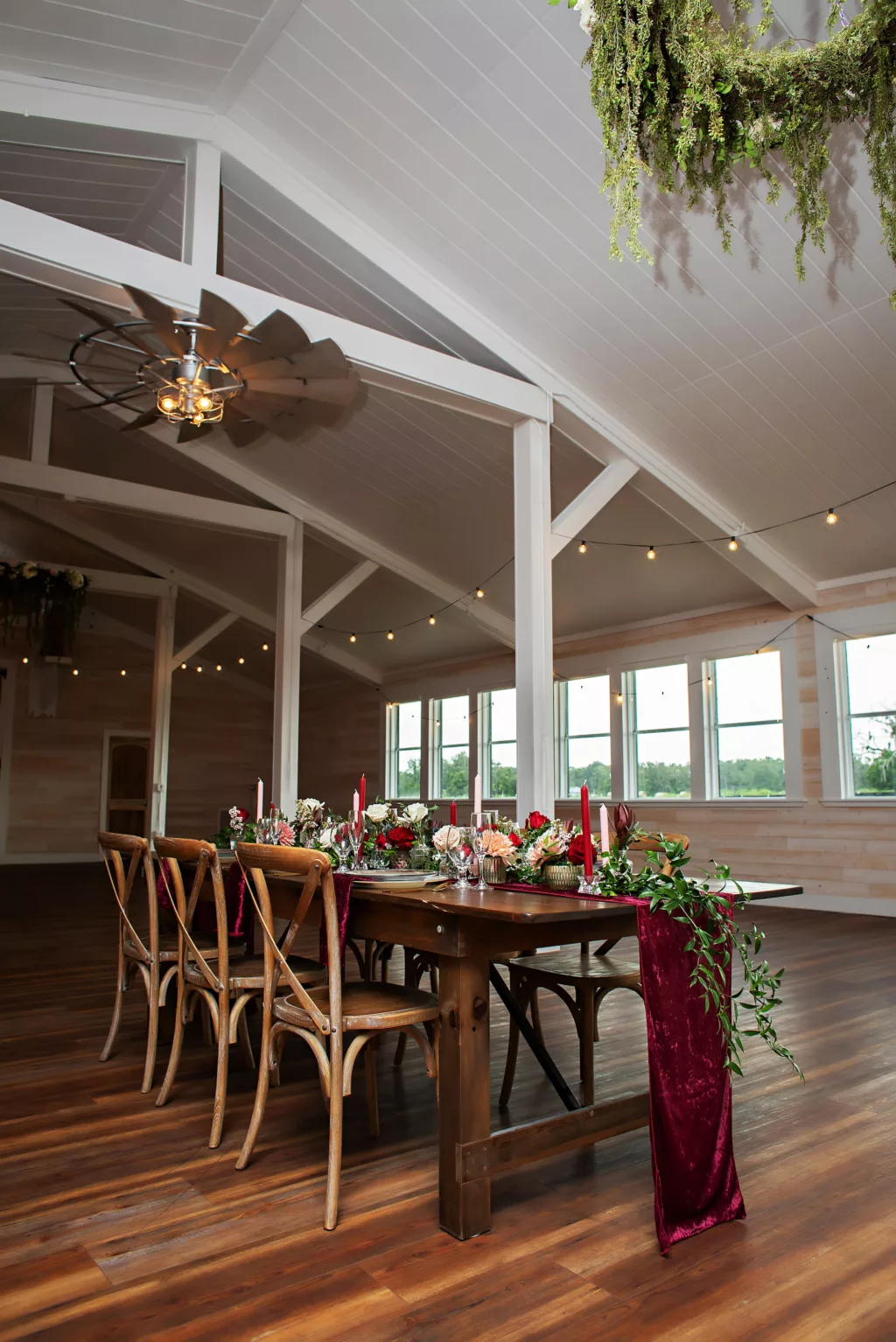 Burgundy Fall Legacy Barn Wedding Reception Inspiration | Rustic Wooden Table | Red and White Taper Candles, Greenery Garland, and Velvet Table Runner Centerpiece Decor Ideas | Tampa Bay Event Venue Legacy Lane Weddings | Tampa Florist Save The Date Florida