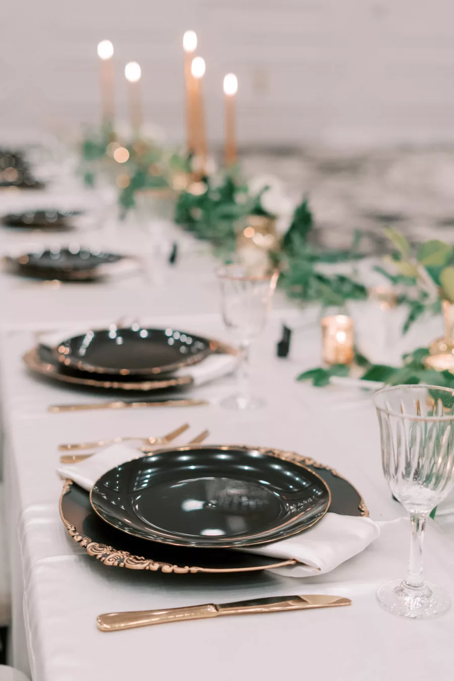 Great Gatsby Inspired Wedding Reception Head Table Tablescape Ideas | Black and Gold Vintage Chargers | Gold Flatware | White Roses, Hydrangeas, Stock Flowers, and Feathers Centerpiece Inspiration | Tampa Bay Outside The Box Rentals