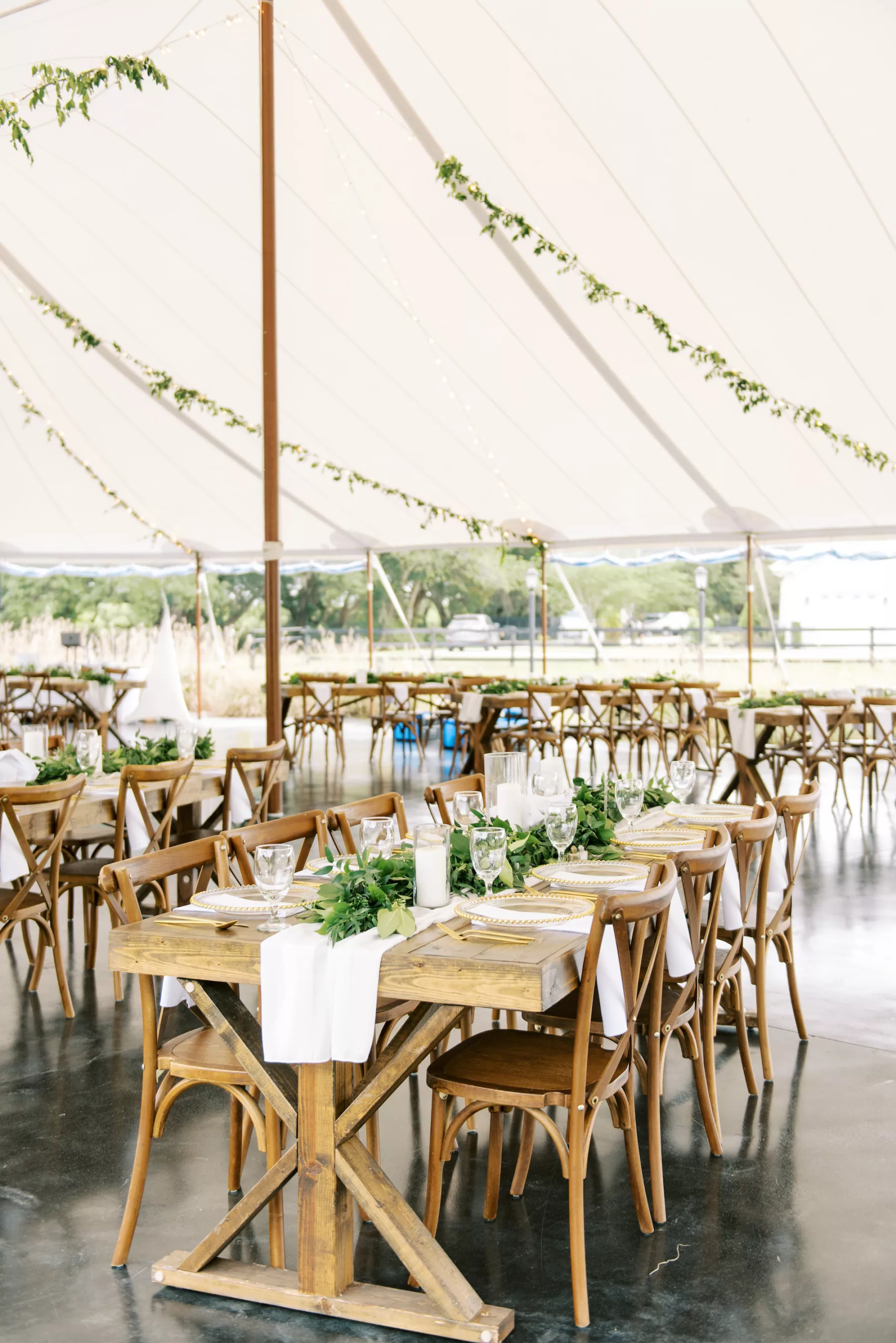 Whimsical Green and White Grand Meadow Tented Wedding Reception Inspiration | Rustic Wooden Tables with Crossback Chairs Ideas | Tampa Bay Event Venue Mill Pond Estate