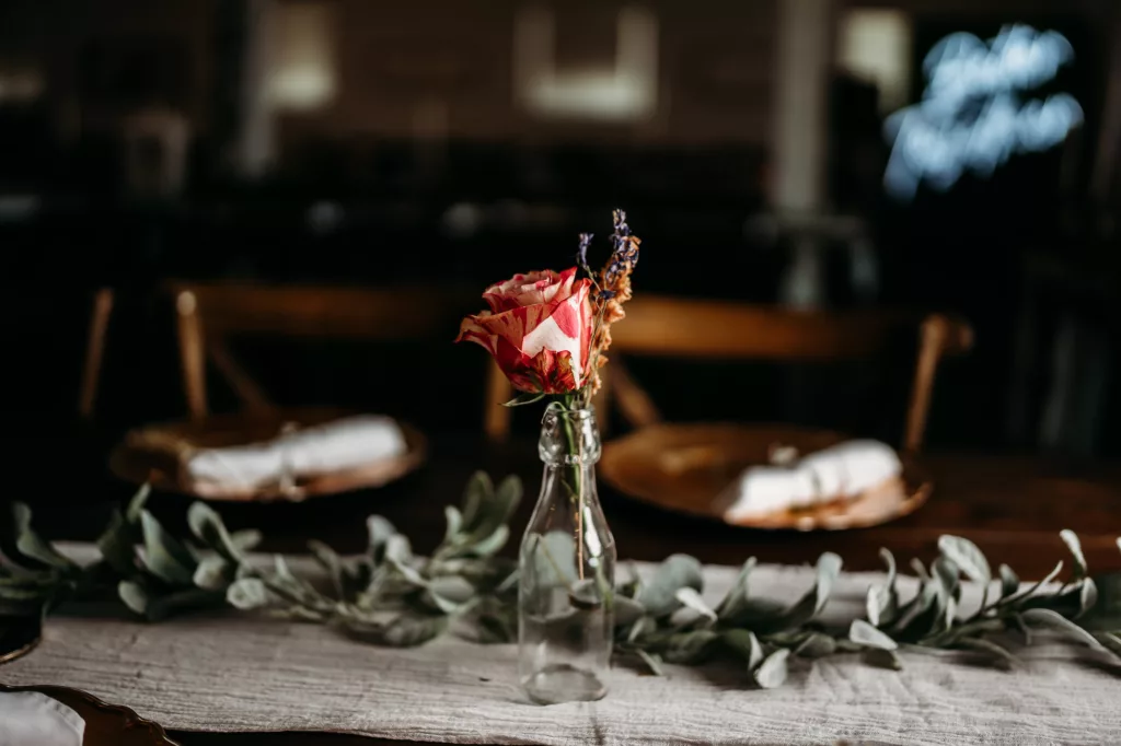 Burgundy Rose in Bud Vase with Eucalyptus Greenery Garland for Boho Wedding Reception Centerpiece Decor Ideas