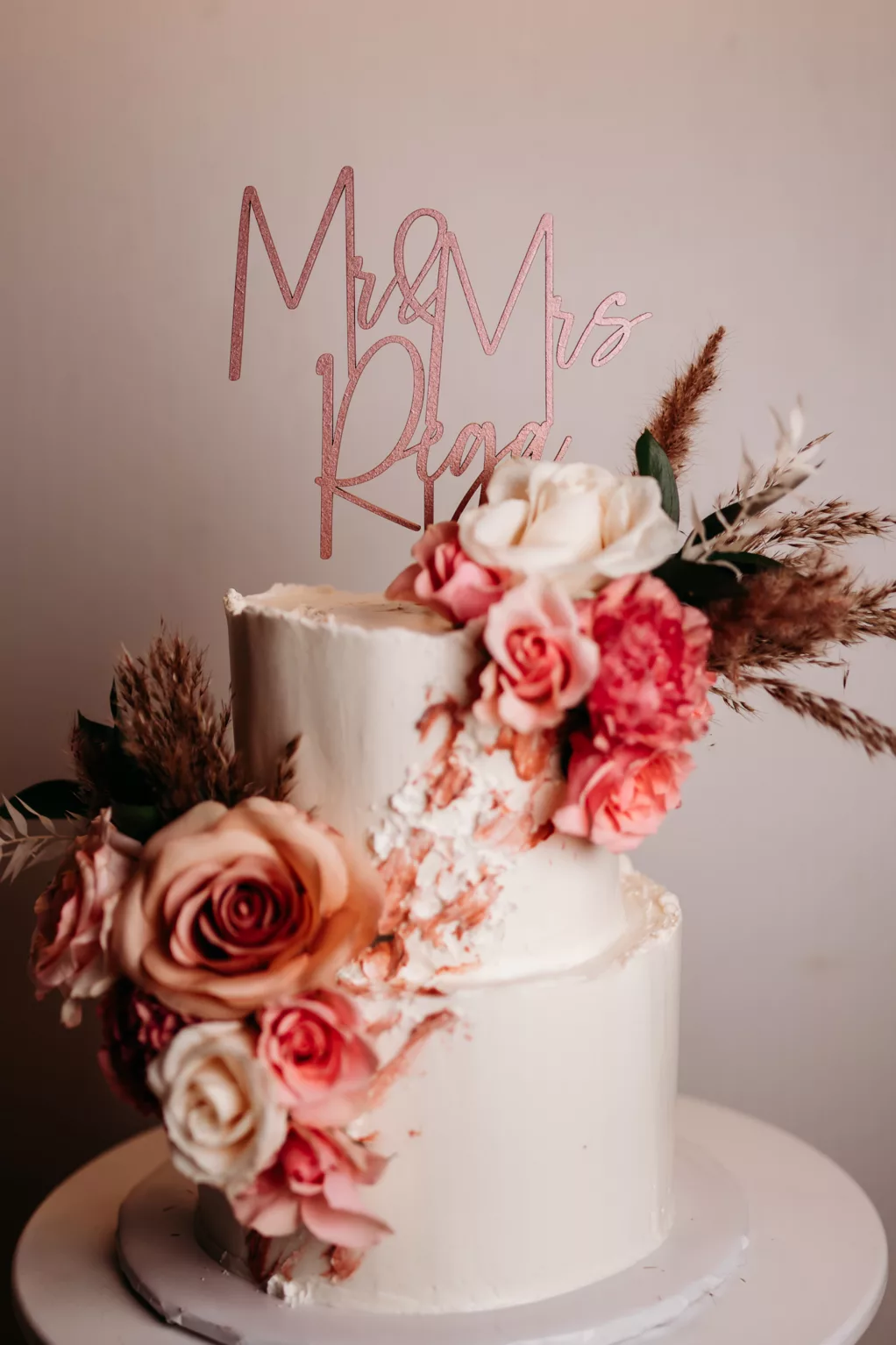 Two-Tiered Raw Deckle Edge Round Wedding Cake with Custom Acrylic Cake Topper and Pink Flower Accents