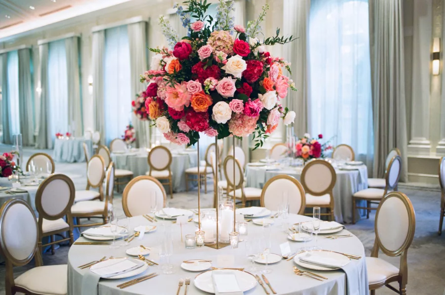 Luxurious Pink and Blue Wedding Reception Tablescape Ideas | Tall Flower Stand with Pink Anemones and Hydrangeas, Orange Garden Roses, Blue Stock Flowers | Gold and White Chairs | Tampa Bay Florist Bruce Wayne Florals | Kate Ryan Event Rentals