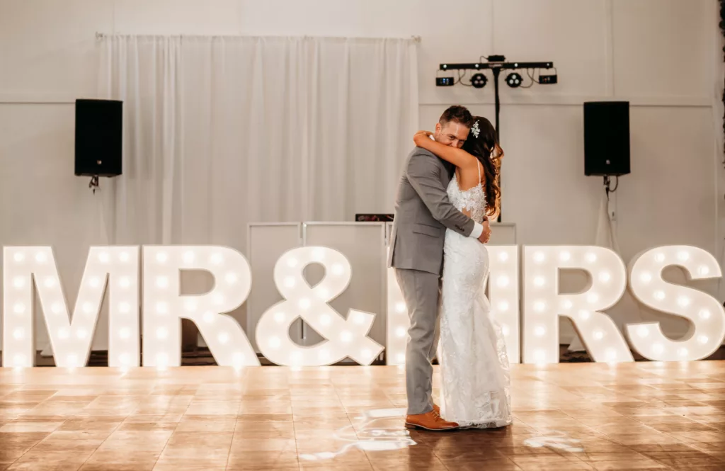 Bride and Groom First Dance Wedding Portrait | Large Mr. and Mrs. Marquee Letter Decor Ideas