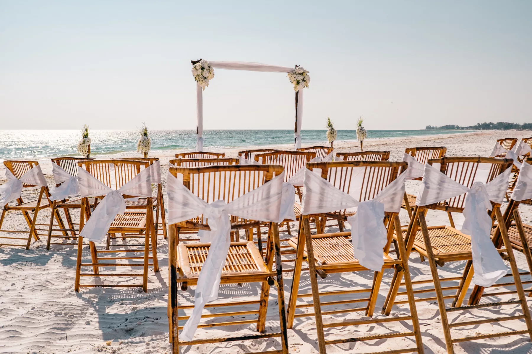 Boho Wedding Ceremony Bamboo Chairs with White Bow Decor Ideas | Planner Gulf Beach Weddings