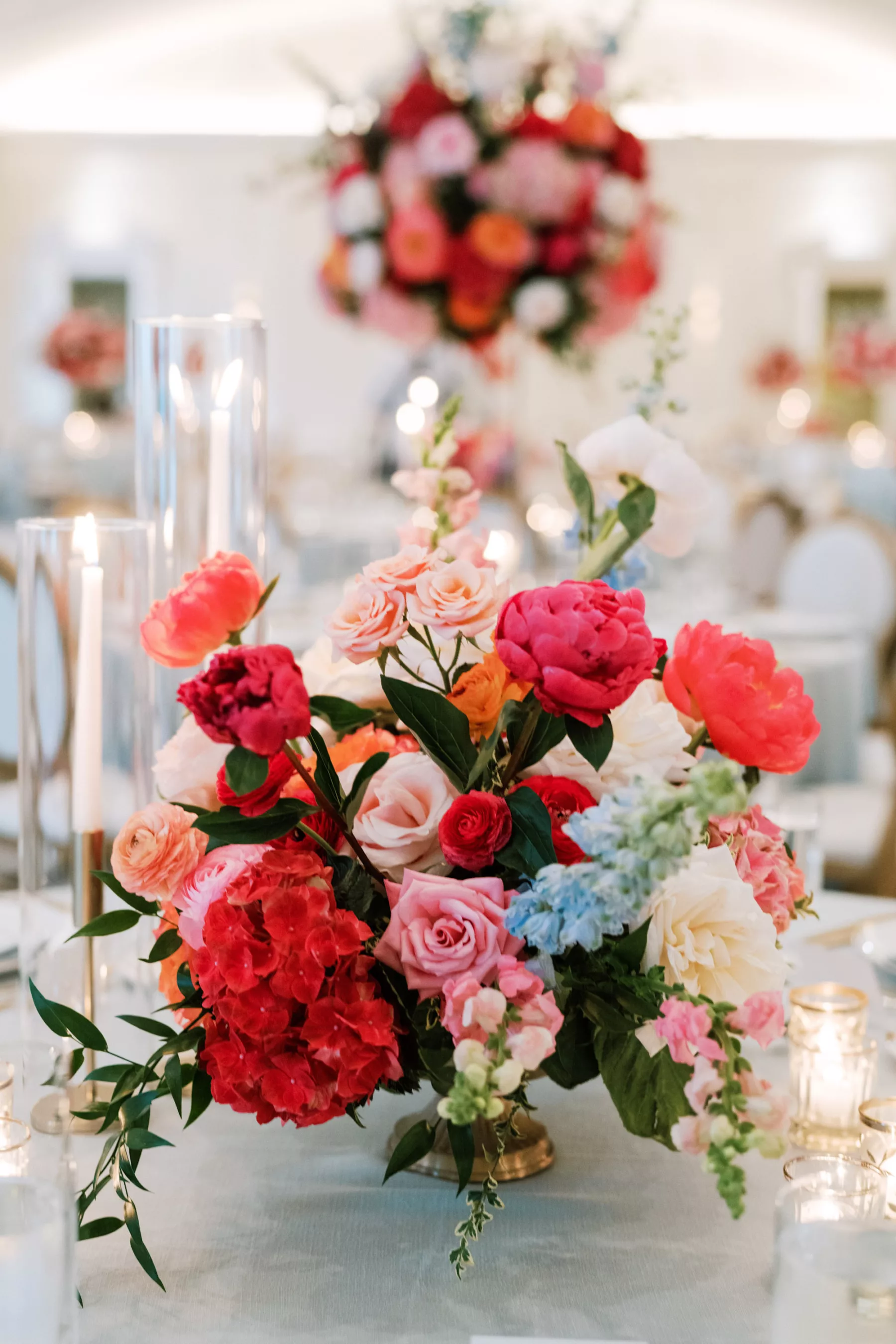 Luxurious Summer Wedding Reception Centerpiece Decor Ideas | Pink Anemones and Hydrangeas, Orange Garden Roses, Blue Stock Flowers | Tampa Bay Florist Bruce Wayne Florals