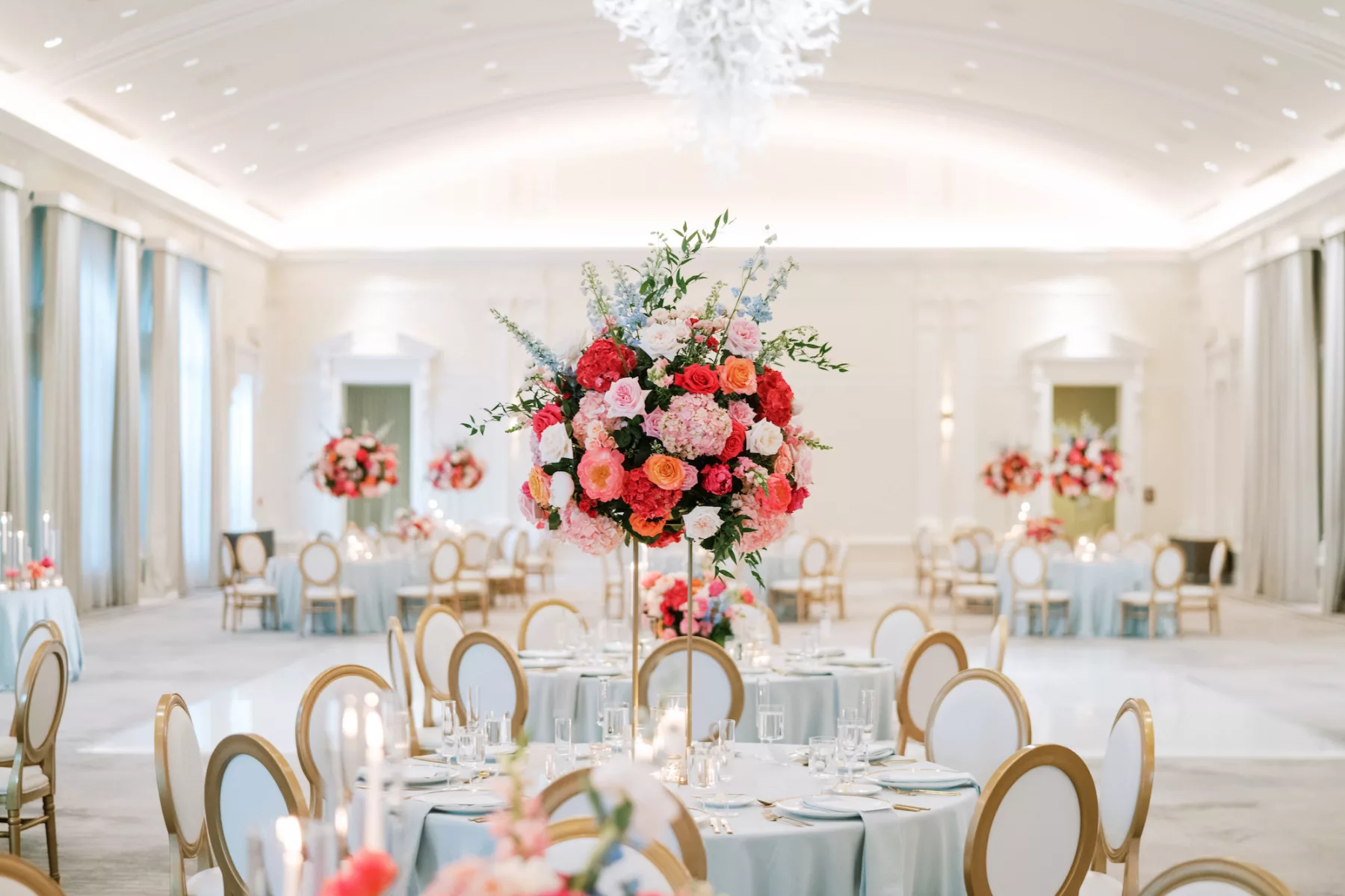 Luxurious Pink and Blue Wedding Reception Centerpiece Tablescape Decor Ideas | Tall Flower Stand with Pink Anemones and Hydrangeas, Orange Garden Roses, Blue Stock Flowers | St Pete Florist Bruce Wayne Florals | Kate Ryan Event Rentals | Venue The Vinoy