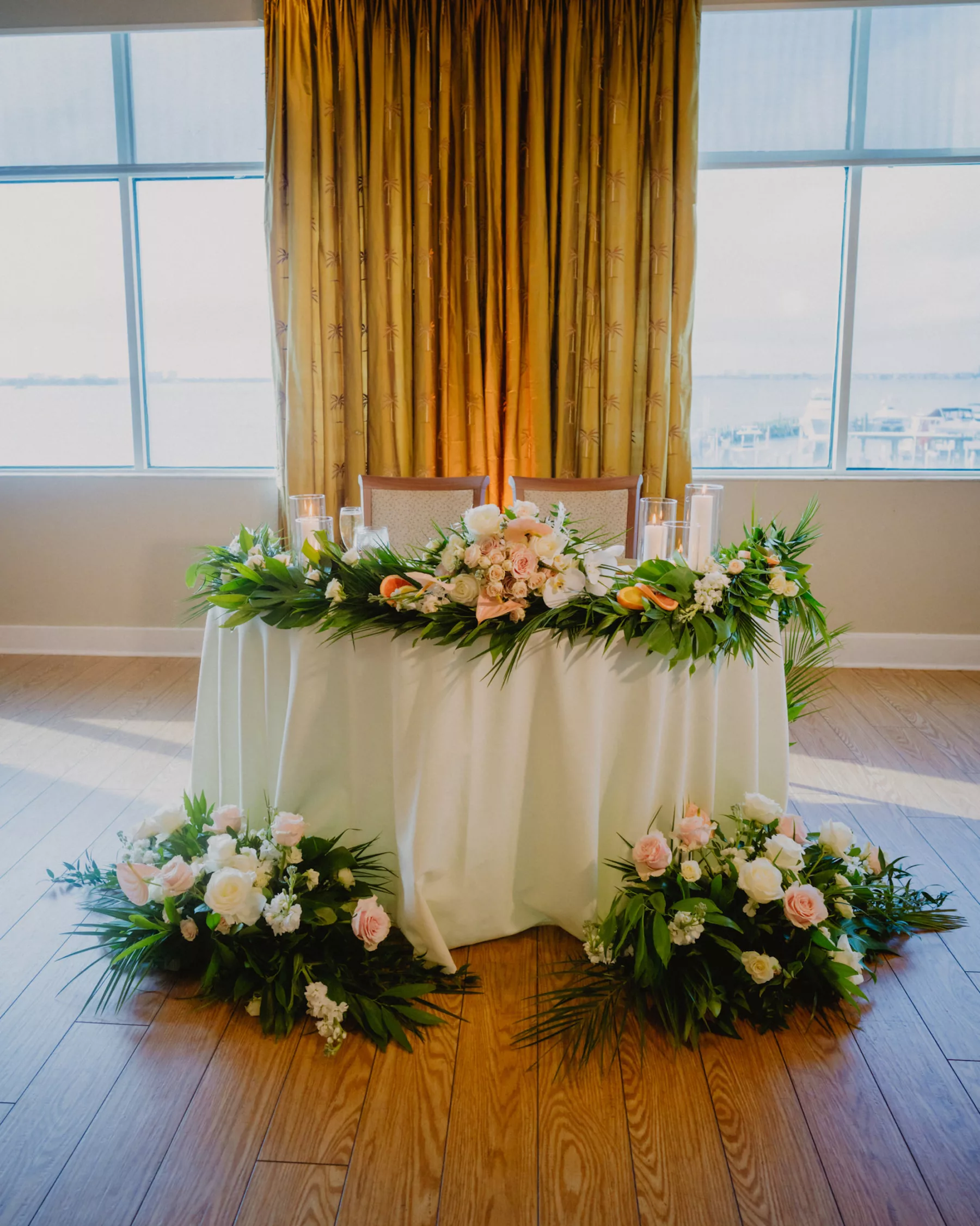 Tropical Wedding Reception Sweetheart Table Decor Inspiration | Elegant Pink and White Roses, Anthurium, Stock Flowers, Monstera Leaf, and Palm Frond Spring Floral Arrangements | Tampa Bay Florist Monarch Events and Design