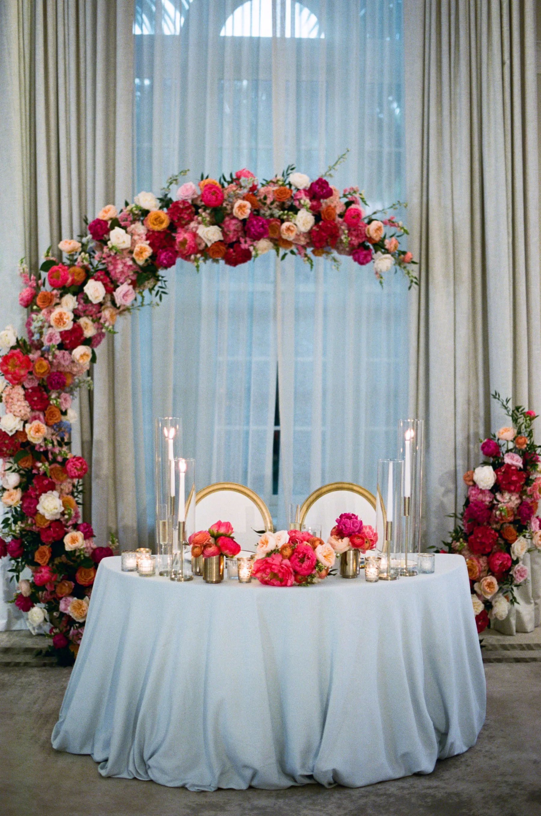 Luxurious Pink and Blue Summer Ballroom Wedding Reception Sweetheart Table Decor Ideas | Round Backdrop with Pink Hydrangeas and Orange Garden Roses | Tampa Bay Florist Bruce Wayne Florals | Event Planner Parties A La Carte | Kate Ryan Event Rentals
