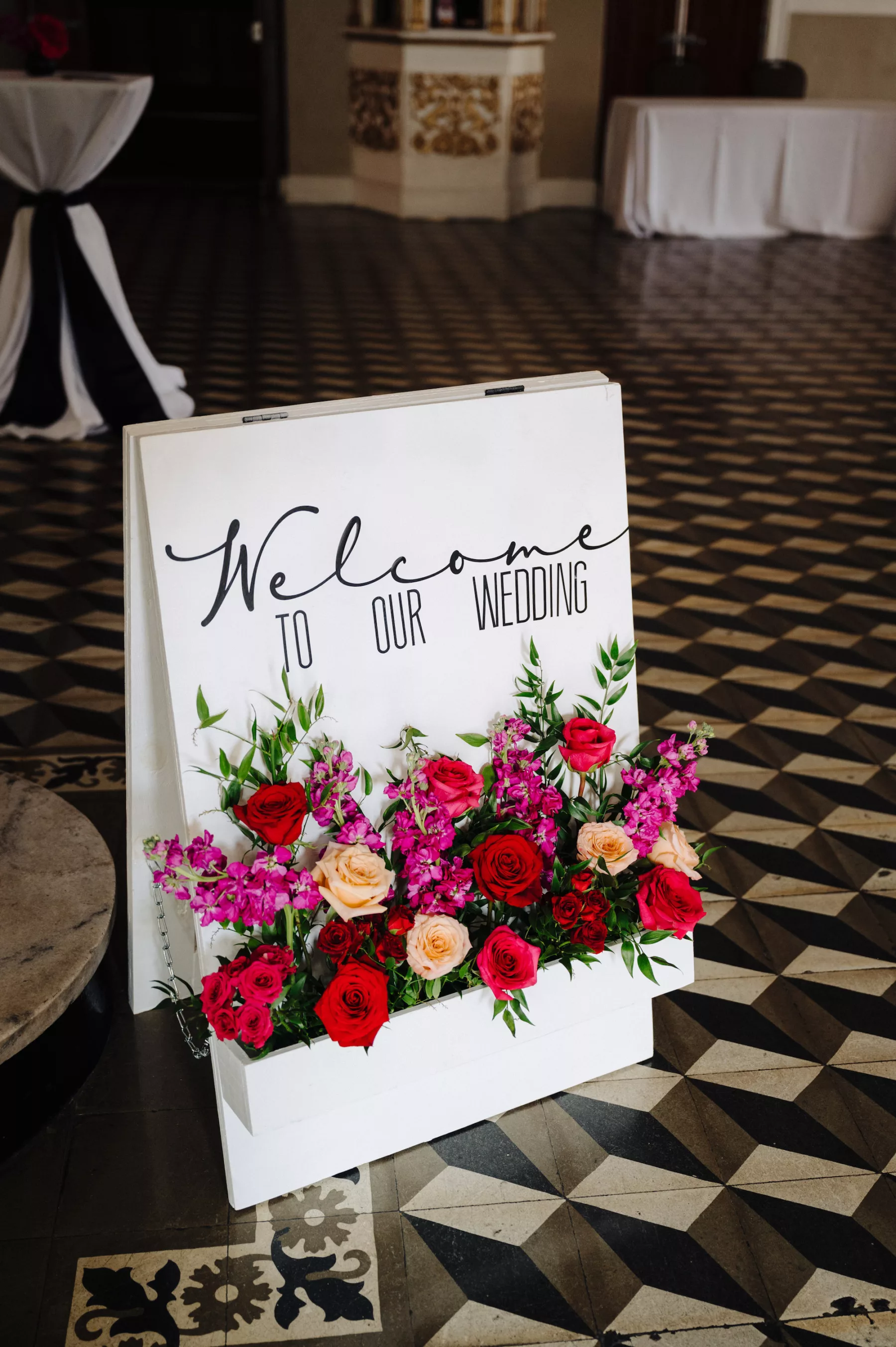 Welcome To Our Wedding Italian Inspired Sign with Flower Box Ideas | Red and Orange Roses, Pink Stock Flowers, and Greenery Floral Arrangement | Tampa Bay Florist Save The Date Florida