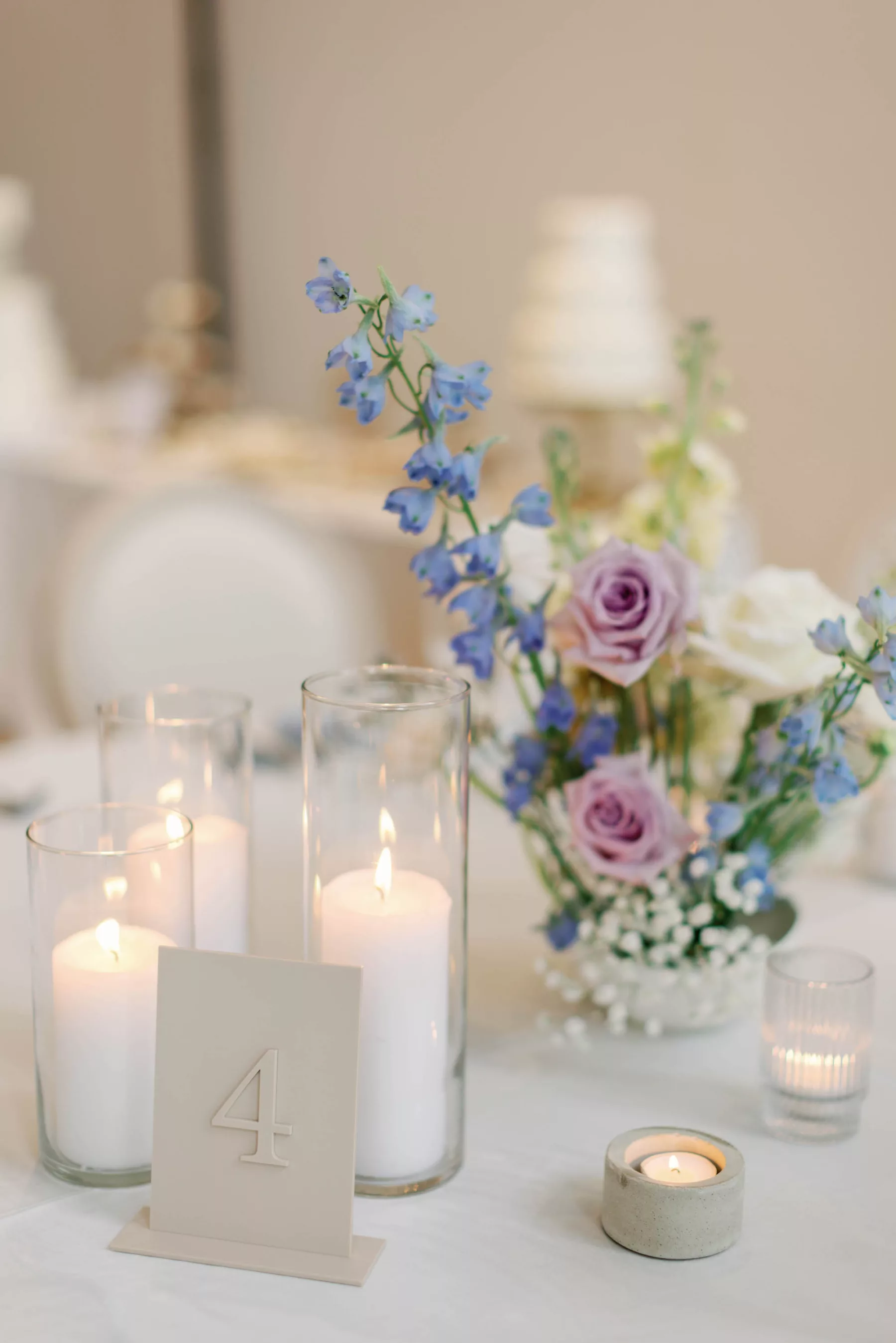 Whimsical Wedding Reception Decor Inspiration | Blue Lily of the Valley, Purple Roses, and White Baby's Breath and Candlelight Centerpiece Ideas