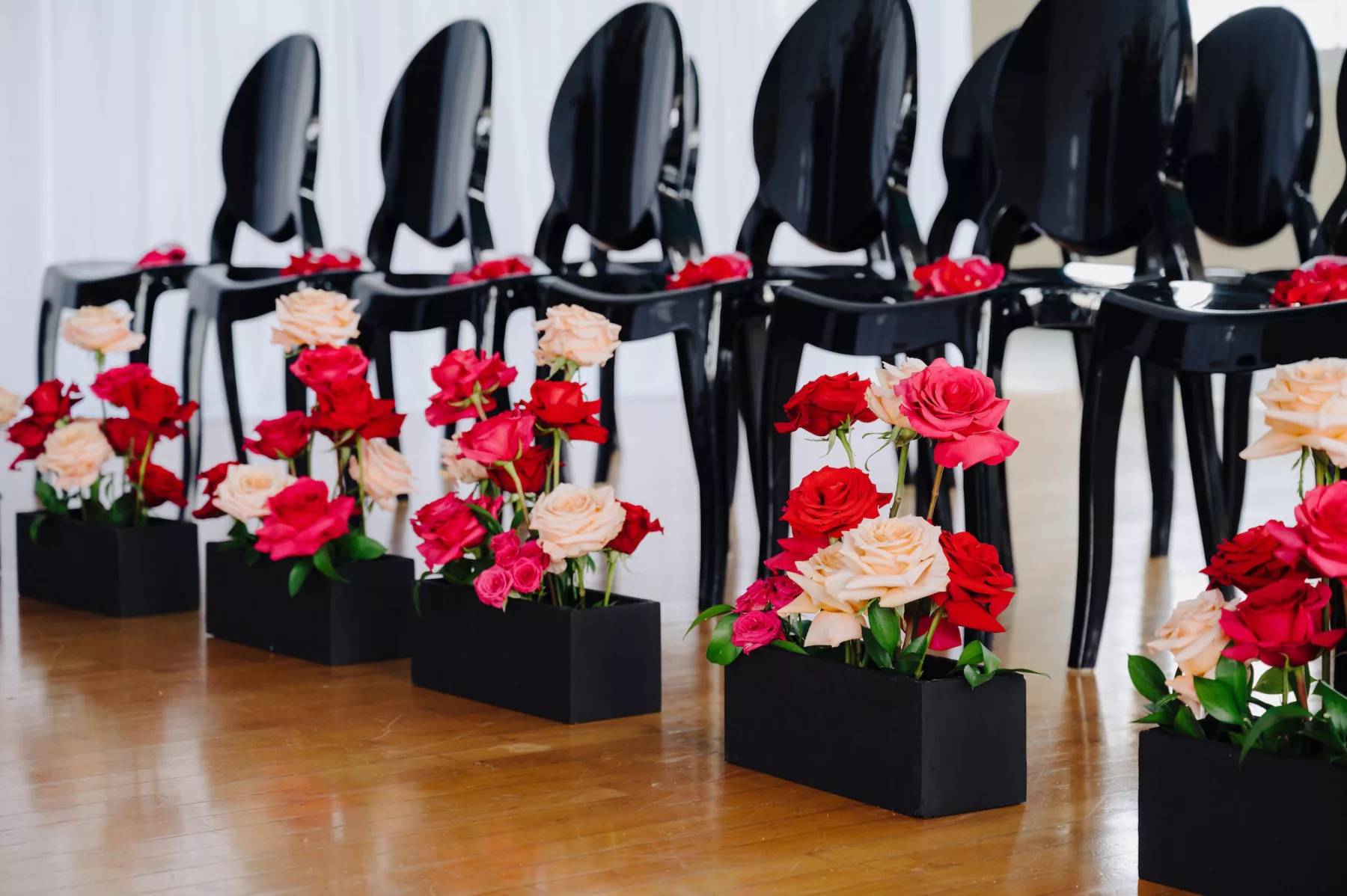 Modern Black and Pink Wedding Ceremony Aisle Decor Ideas | Bold Pink and Red Roses in a Black Flower Box | Black Ghost Chairs | Tampa Bay Florist Save The Date Florida | Ybor Planner Eventfull Weddings | Rentals A Chair Affair