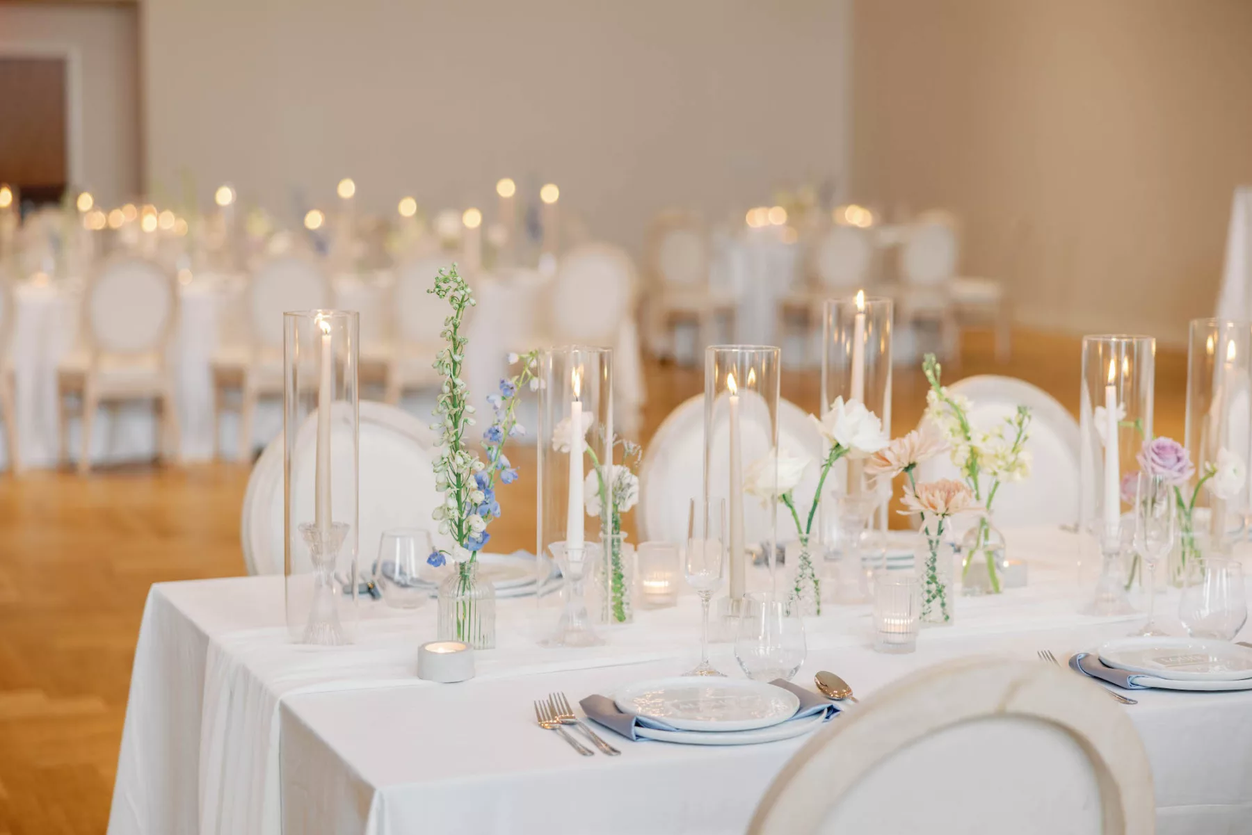 Whimsical Spring Wedding Reception Centerpiece Tablescape Decor Ideas | Blue Lily of the Valley, White Carnations, Pink Chrysanthemums, and Purple Roses in Bud Vases