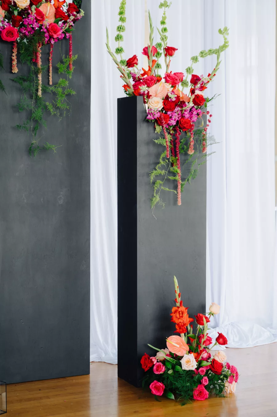 Unique Black Spring Wedding Ceremony Altar Backdrop with Bold Pink and Red Roses, Orange Anthurium and Greenery | Tampa Bay Florist Save The Date Florida