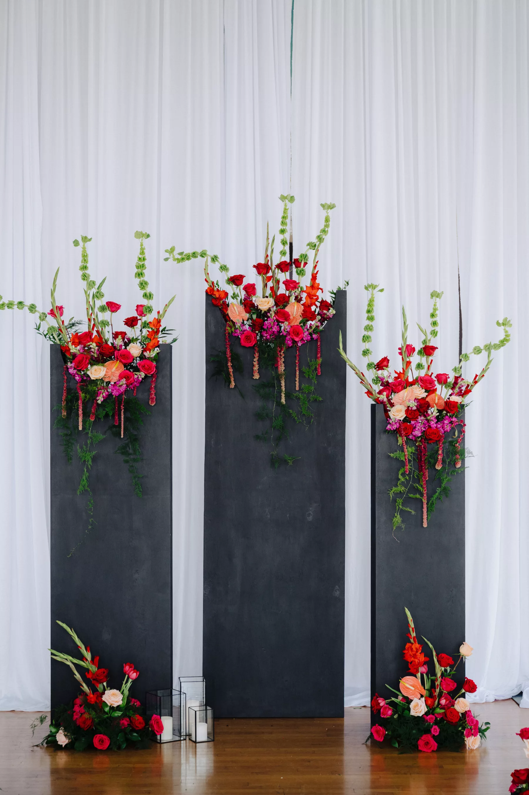Modern Black and Pink Italian Inspired Spring Wedding Ceremony Ideas | Unique Black Altar Backdrop with Bold Pink and Red Roses, Orange Anthurium and Greenery | Tampa Bay Florist Save The Date Florida