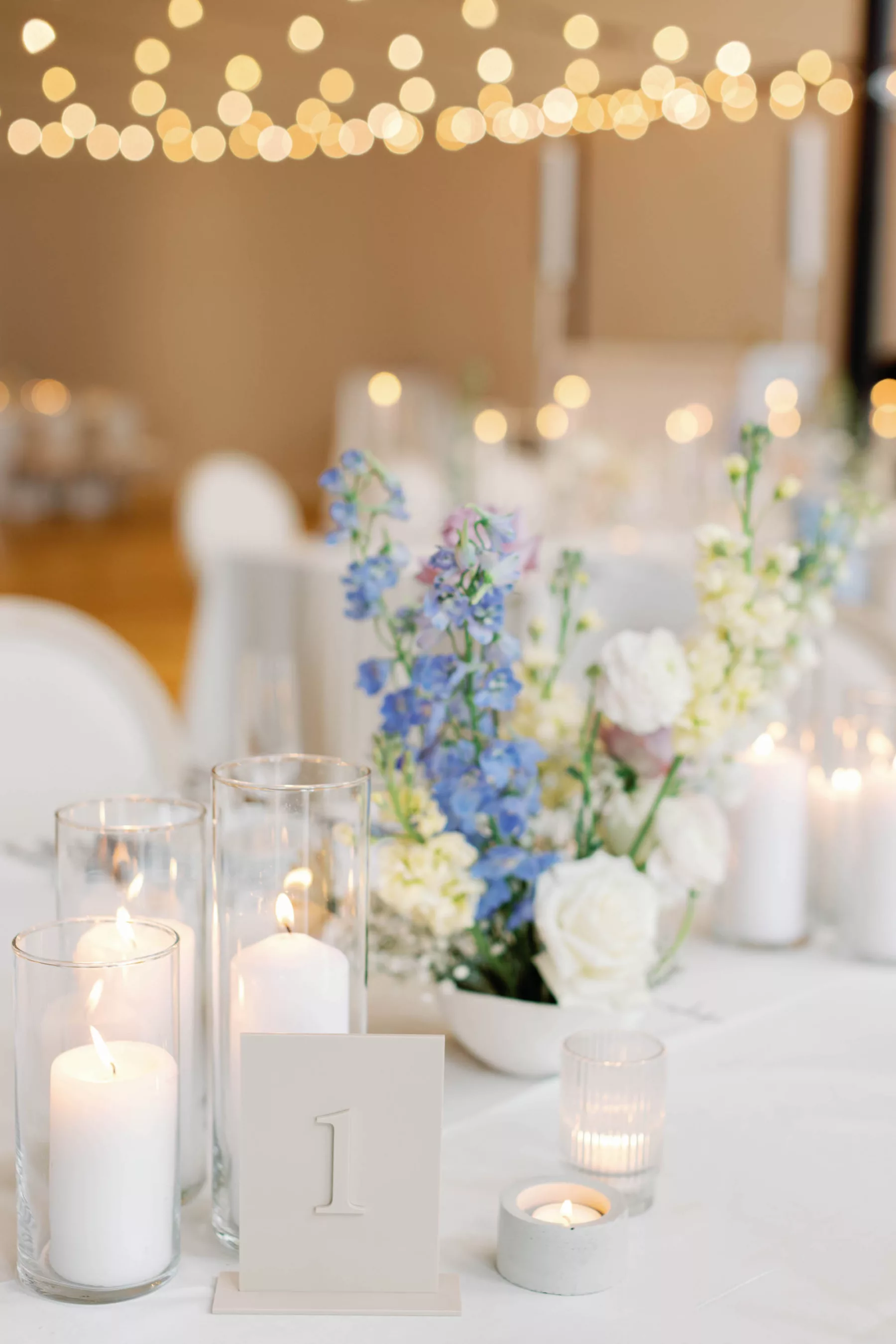 Whimsical Wedding Reception Centerpiece Decor Inspiration | Blue Lily of the Valley, White Roses, and Candlelight