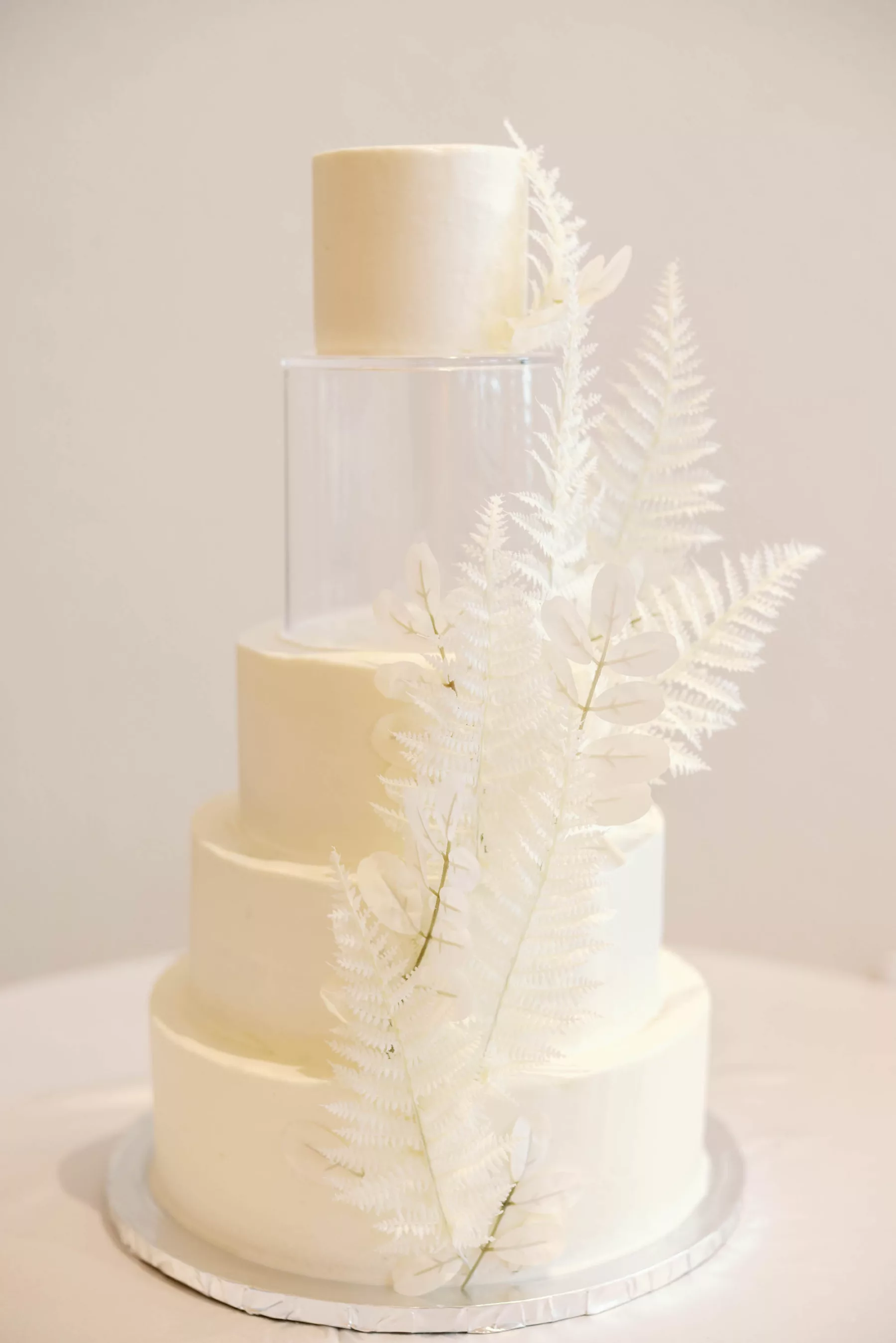 White Round Buttercream 5-Tiered Wedding Cake Inspiration with Acrylic Tier and White Fern Accent