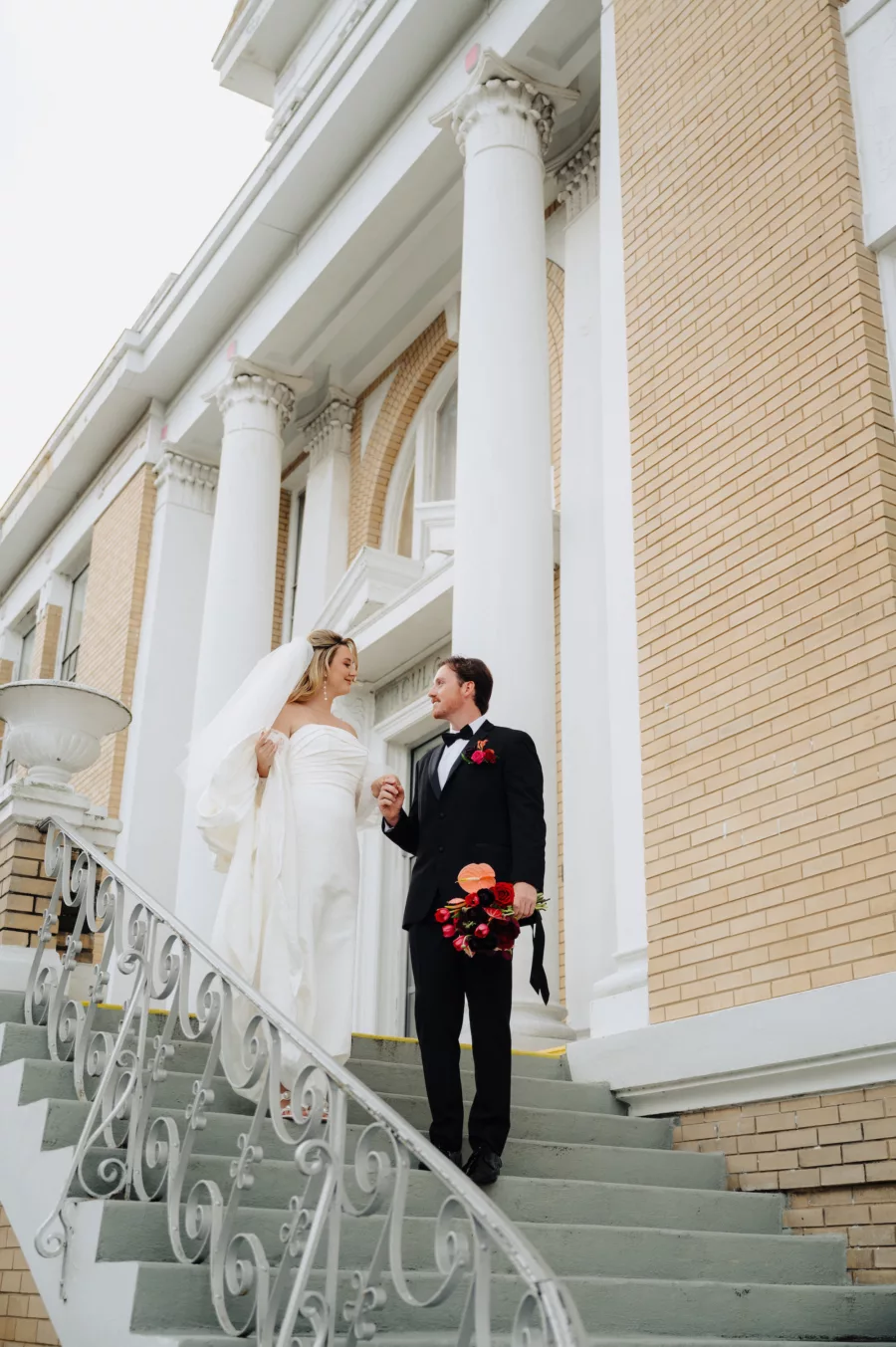 Bride and Groom Walking Down Stairs Wedding Portrait | Historic Ybor Event Venue Cuban Club | Tampa Bay Photographer McNeile Photography | Content Creator Behind The Vows
