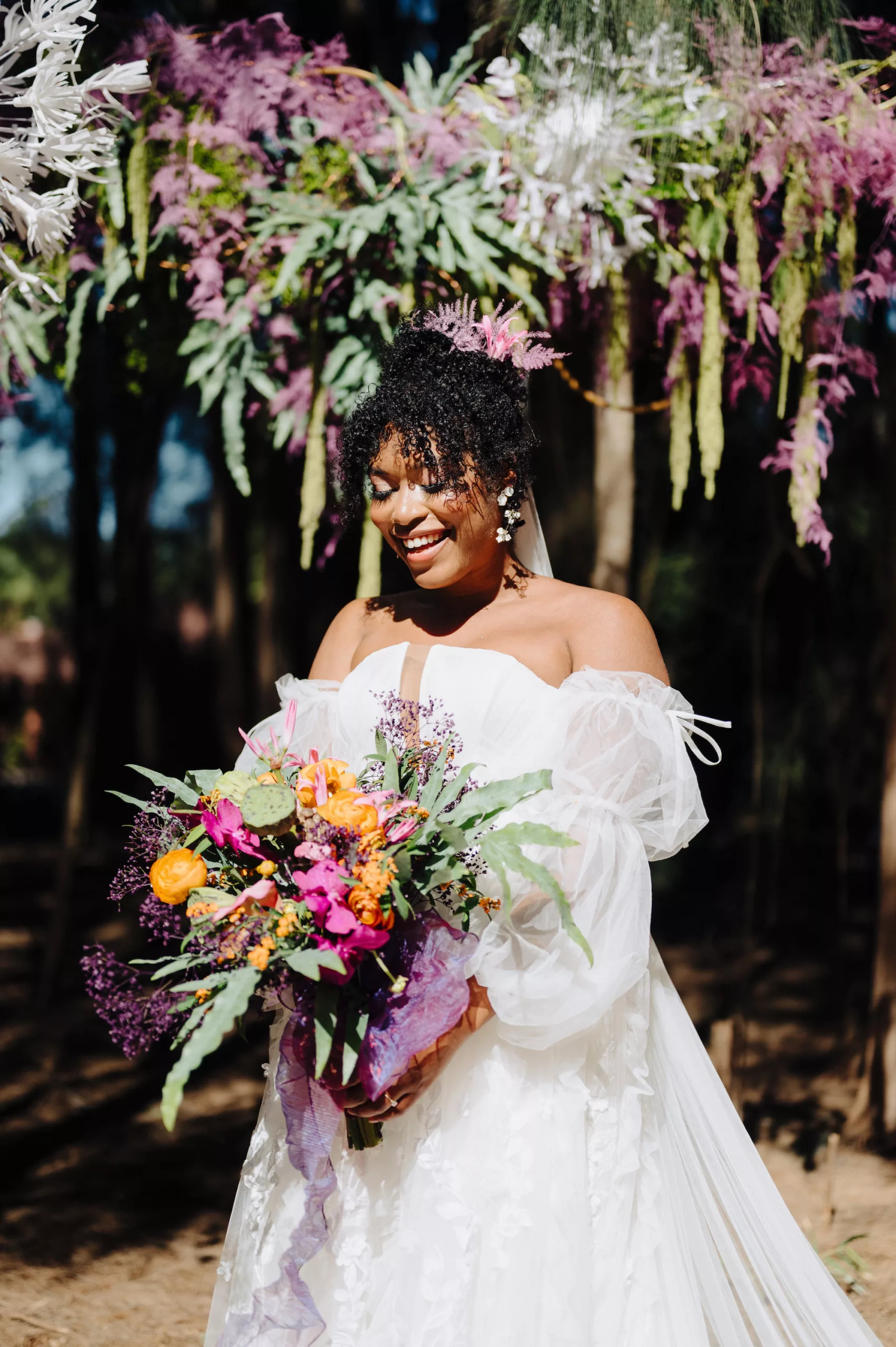 Whimsical Orange Anemones, and Roses, Purple and Pink Flower Spring Wedding Bouquet Ideas | White Strapless Tulle Wedding Dress with Removable Sleeves Inspiration | Tampa Bay Photographer McNeile Photography | Content Creator Behind The Vows | Planner Wilder Mind Events