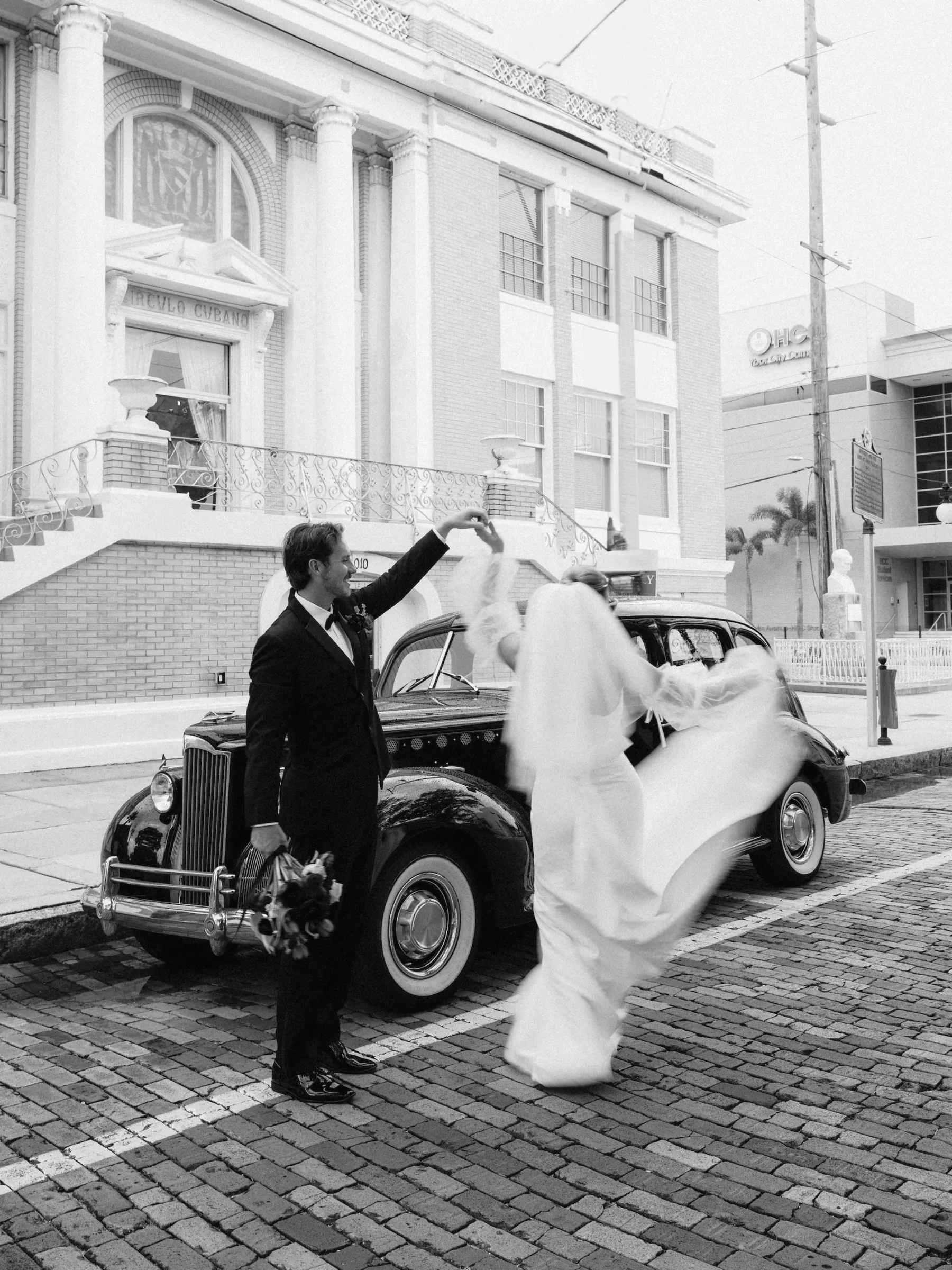 Bride and Groom Dancing in the Road with Classic Wedding Day Getaway Car Ideas | Tampa Bay Car Rental Classically Ever After | Photographer McNeile Photography | Planner EventFull Weddings | Content Creator Behind the Vows