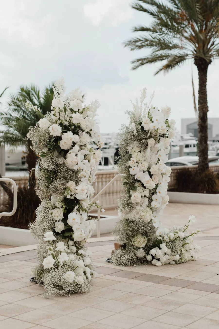 Tall Spring Wedding Ceremony Flower Arrangement Decor with White Roses, Carnations, Baby's Breath, and Orchids Inspiration