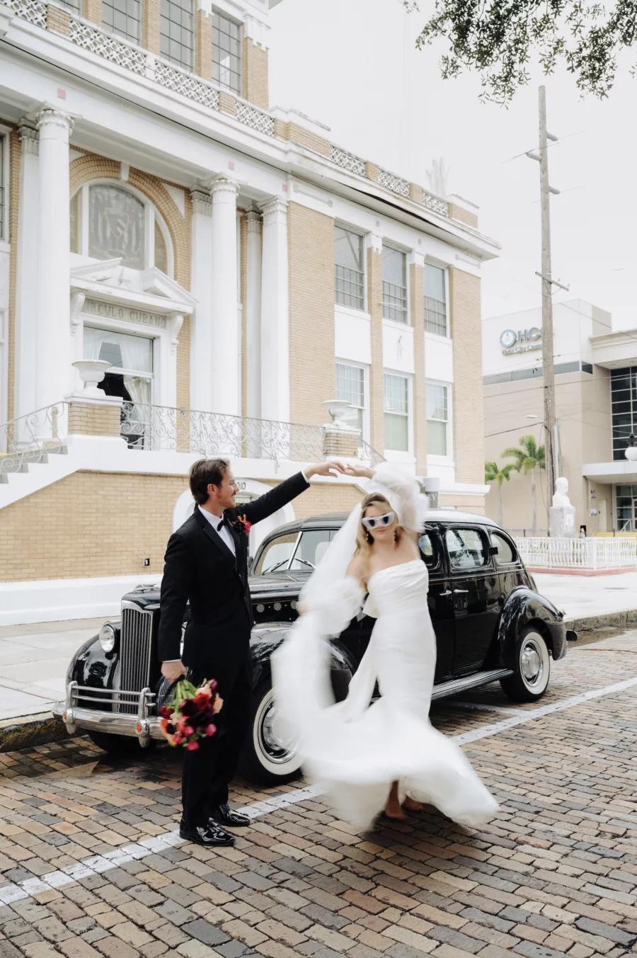 Bride and Groom Dancing in the Road with Classic Wedding Day Getaway Car Ideas | Tampa Bay Car Rental Classically Ever After | Photographer McNeile Photography | Planner EventFull Weddings | Content Creator Behind the Vows