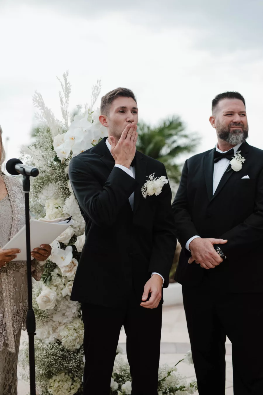 Groom Blowing Kiss to Bride Walking Down Wedding Aisle