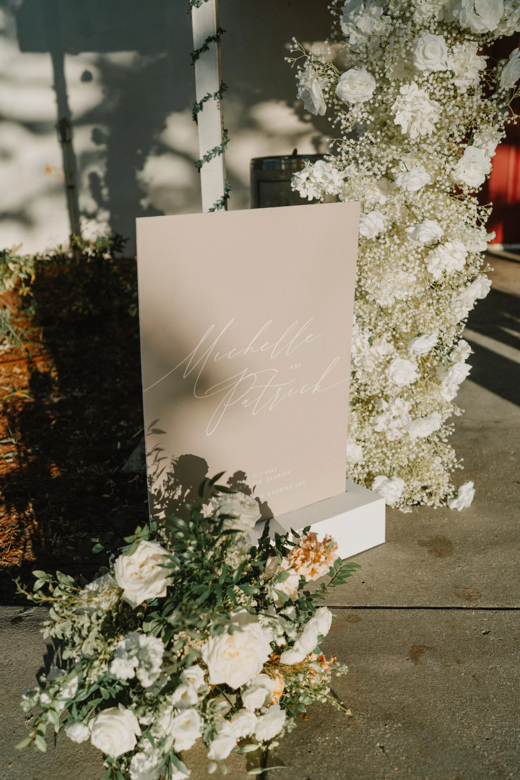 Neutral White and Champagne Wedding Sign Ideas | White Roses, Pink Carnation, and Baby's Breath Floral Arrangement