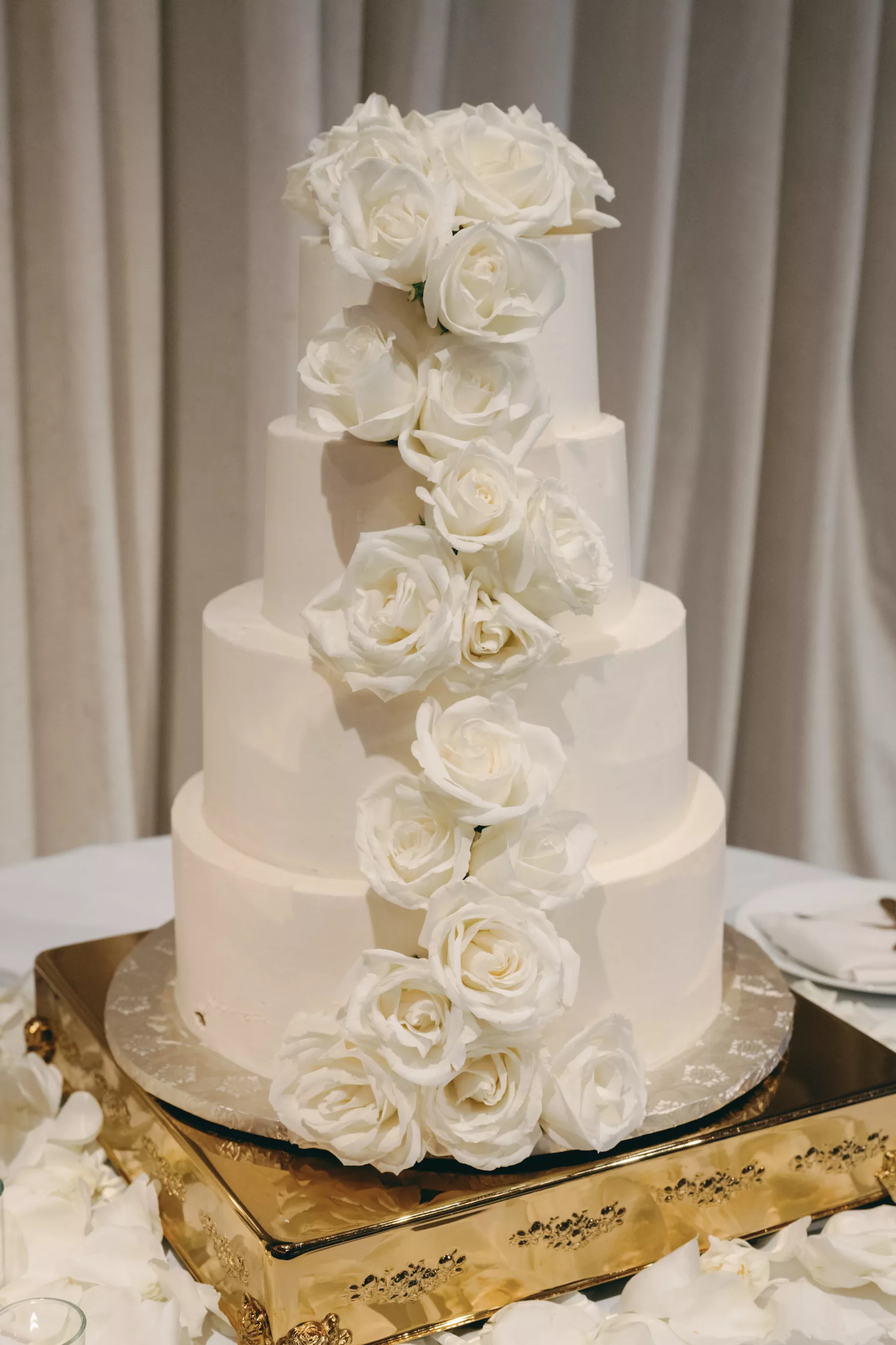 Round White Four Tiered Wedding Cake with Cascading White Roses Ideas