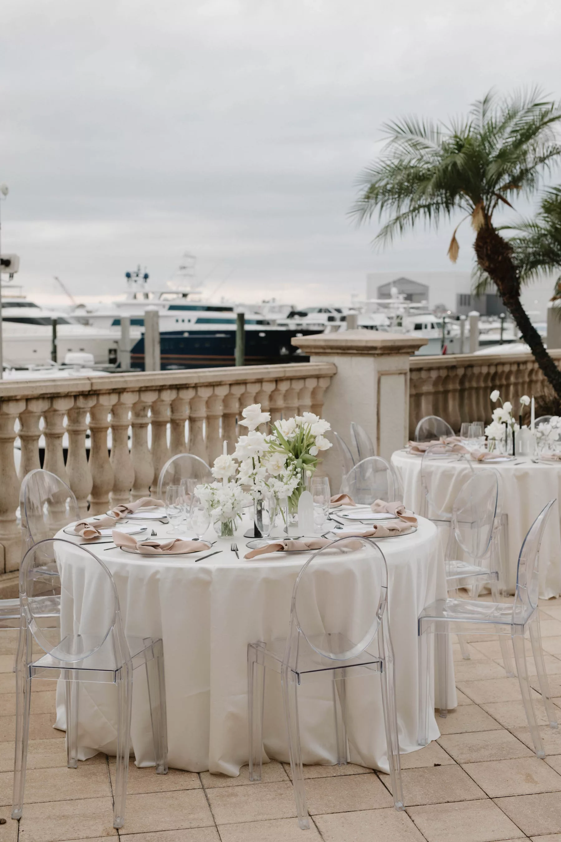 Timeless Oceanview Poolside White and Champagne Spring Wedding Reception Ideas | White Hydrangea, Orchid, and Rose Centerpiece Decor | Acrylic Ghost Chairs | Tampa Bay Kate Ryan Event Rentals | Venue Westshore Yacht Club