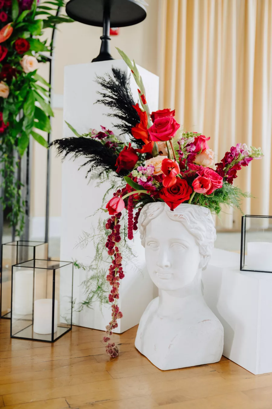 Modern Wedding Cake Table Decor Ideas | Bust with Pink and Red Roses, Black Pampas Grass, and Greenery Flower Arrangement Inspiration