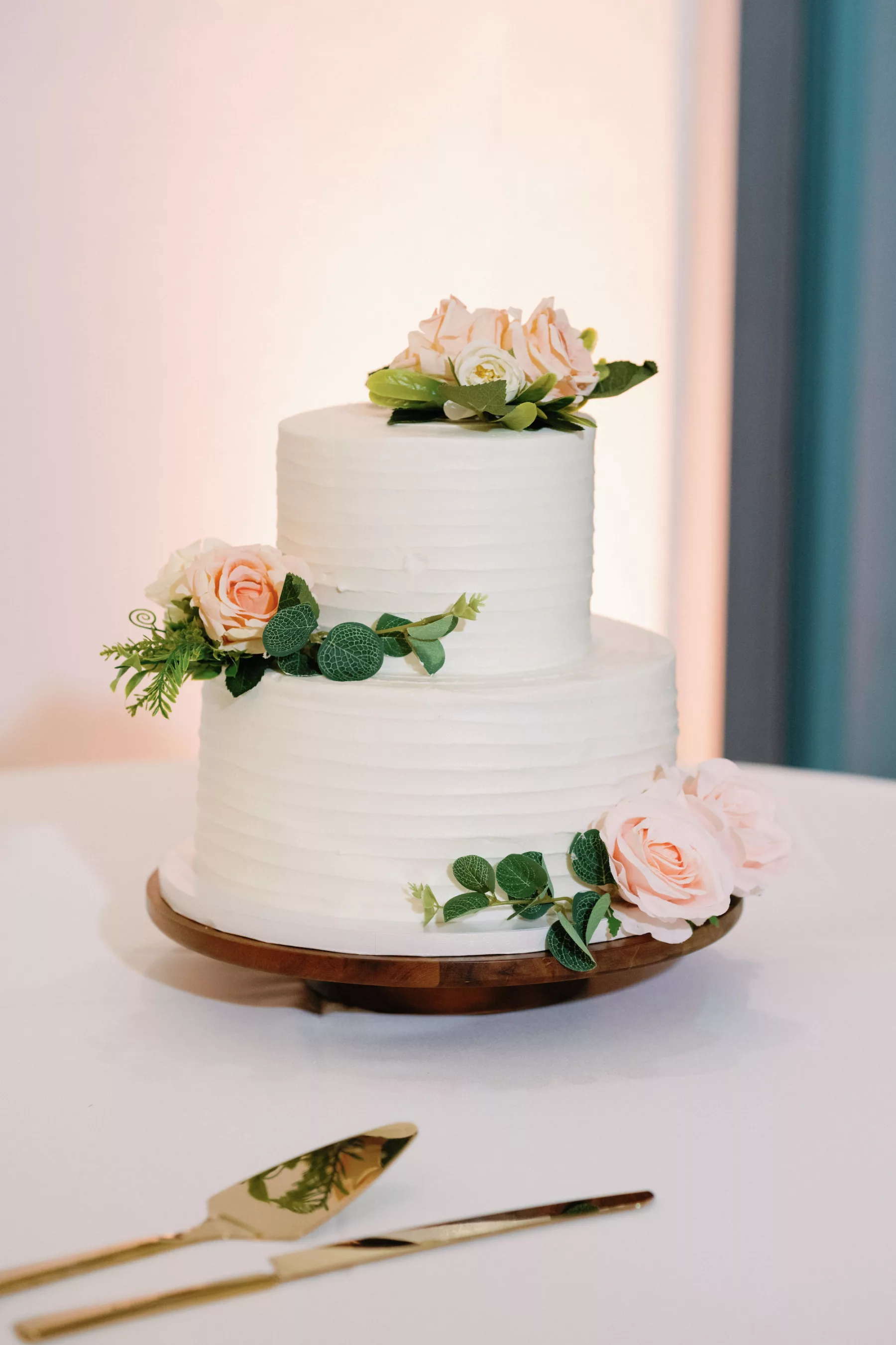 Round Two-Tiered White Buttercream Wedding Cake Inspiration with Pink Roses and Greenery
