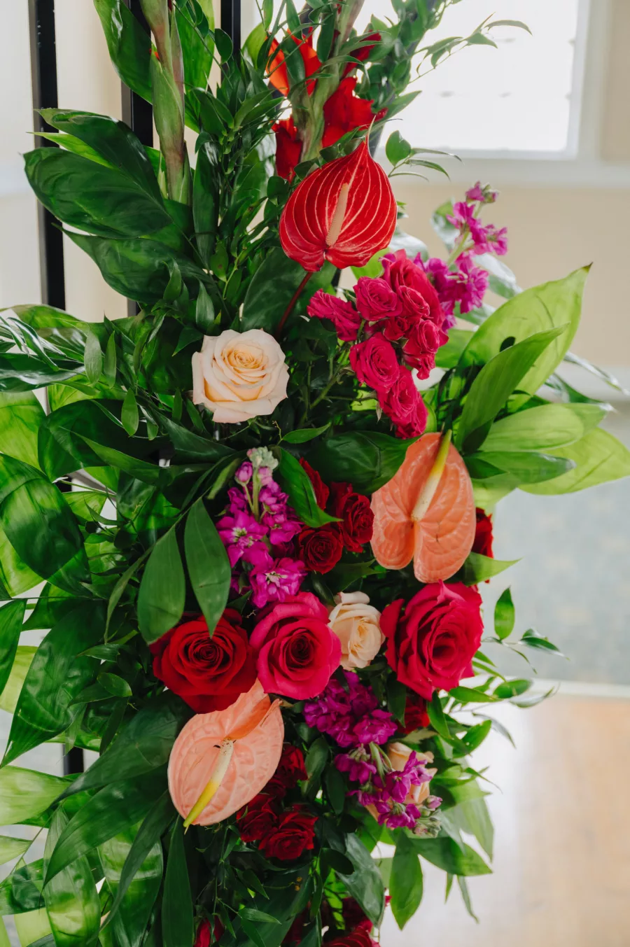 Cake Table Arbor Floral Arrangement with Pink and Red Roses, Red Anthurium, Pink Stock Flowers, and Greenery | Tampa Bay Florist Save The Date Florida