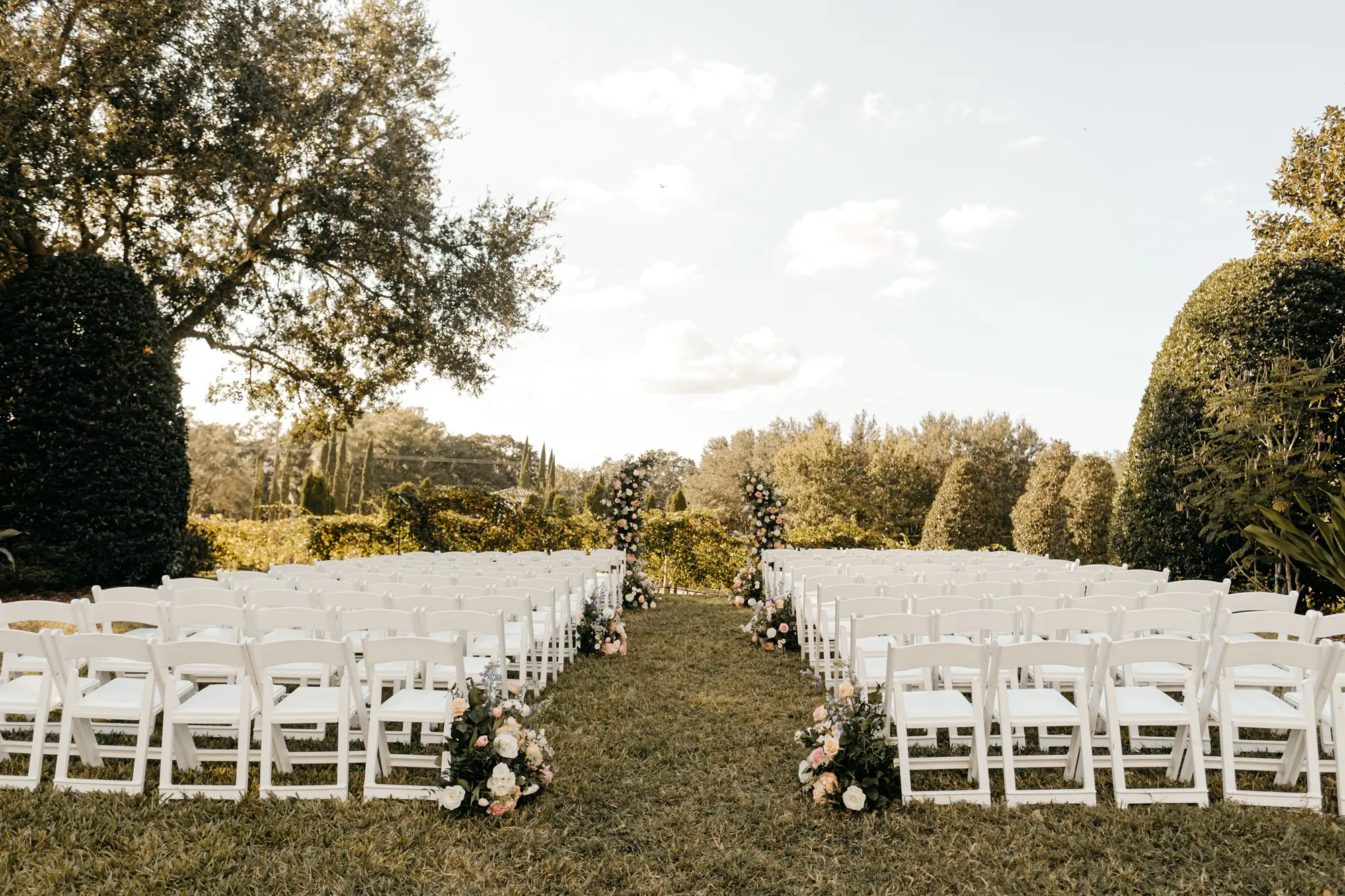 Spring Outdoor Vineyard Wedding Ceremony Decor Inspiration | White Folding Garden Chairs | Tampa Bay Event Planner Coastal Coordinating | Venue Mision Lago Estate