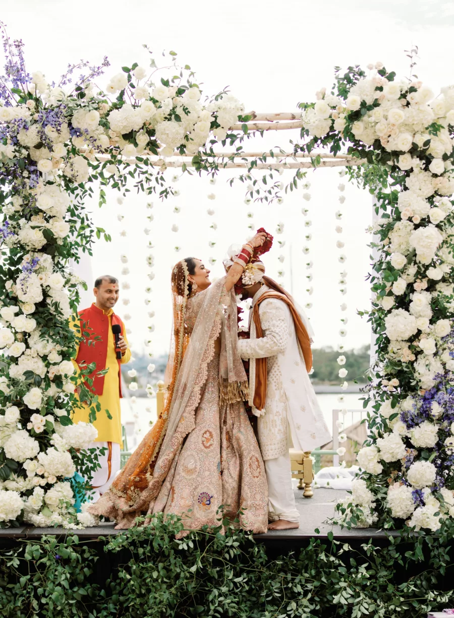 Bride and Groom Hindu Indian Wedding Ceremony Decor Inspiration | Red Rose Varmala Ideas | Elegant Floral Arch with White Roses, Hydrangeas, and Greenery Flower Arrangement