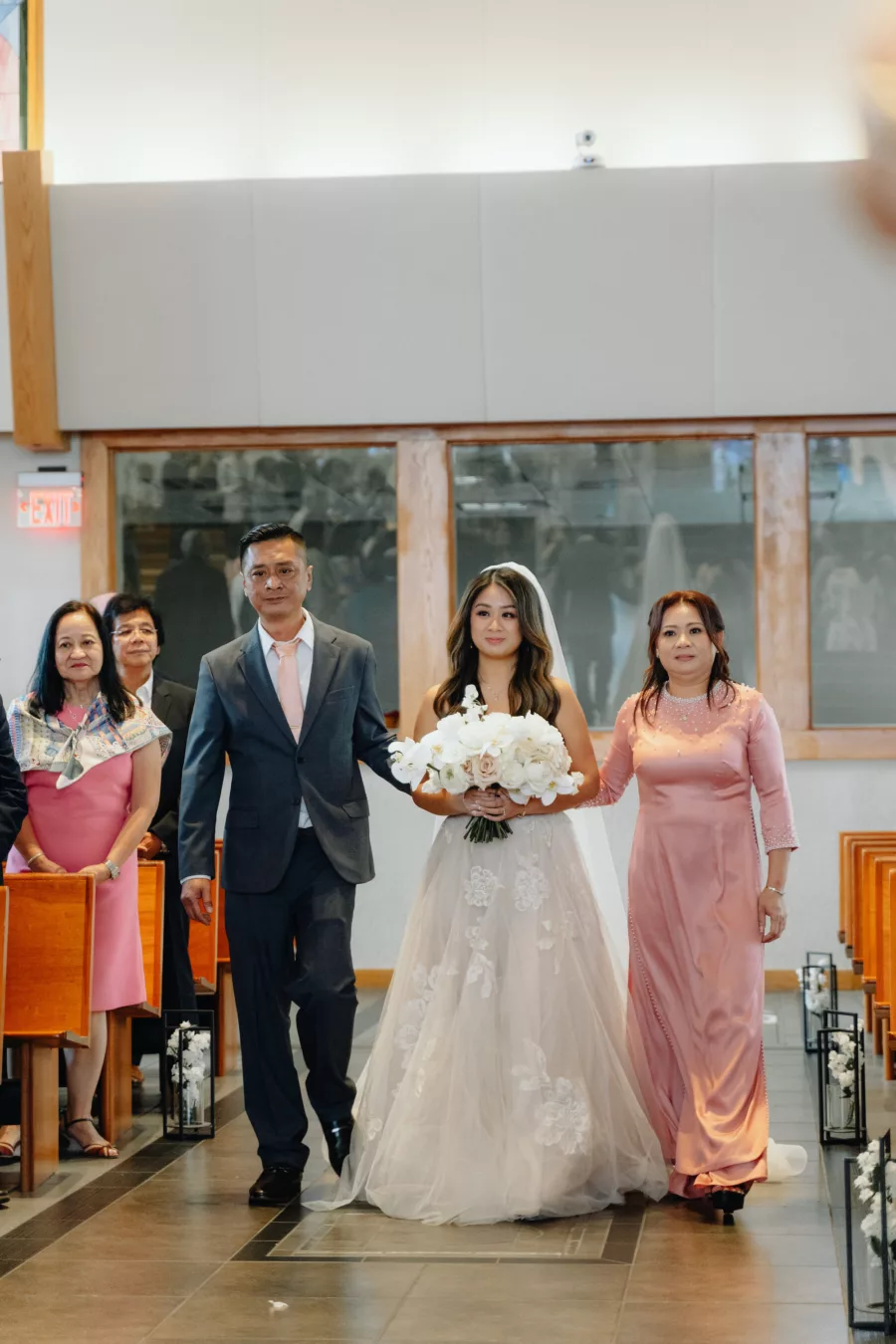 Bride and Parents Walking Down Wedding Aisle