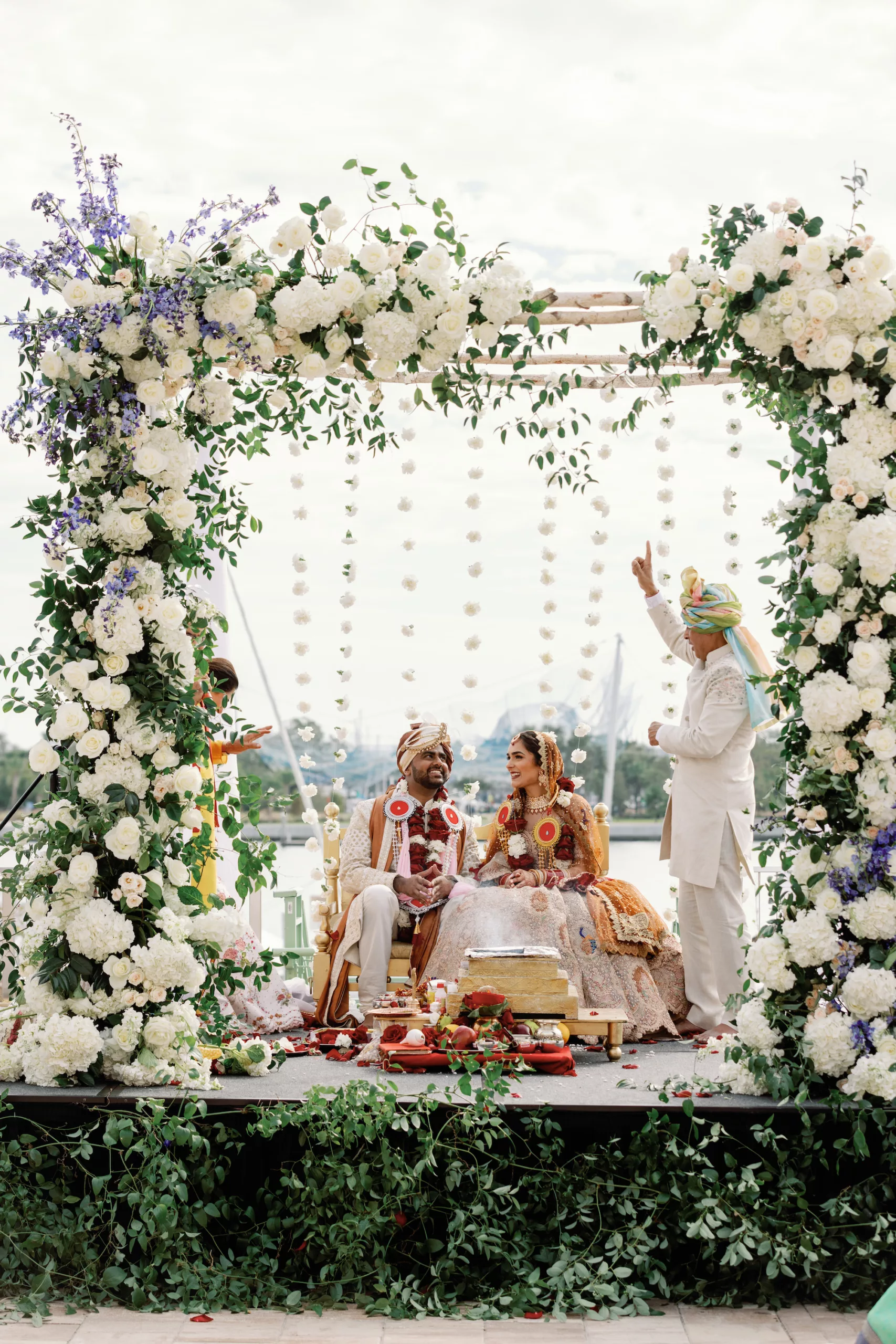 Luxurious Hindu Wedding Ceremony Decor Ideas | Elegant Floral Arch with White Roses, Hydrangeas, and Greenery Flower Arrangement Inspiration | St Pete Event Planner Coastal Coordinating