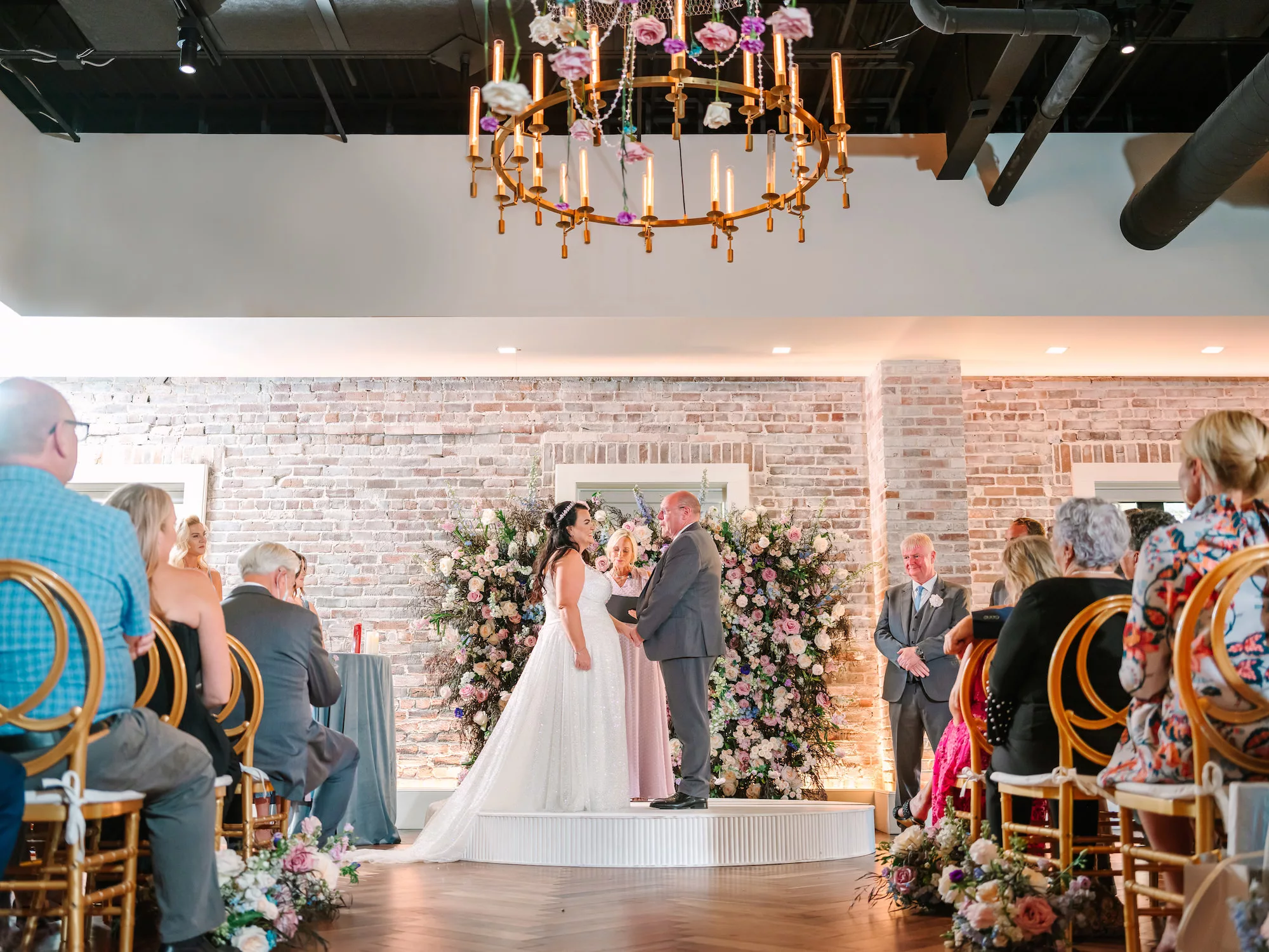 Whimsical Indoor Wedding Reception Ideas | Whimcial Pink Roses, White Hydrangeas, Blue Stock Flowers, and Greenery Backdrop Inspiration | Hanging Rose and Carnation Chandelier | Downtown St. Pete Venue Red Mesa Events | Planner Wilder Mind Events