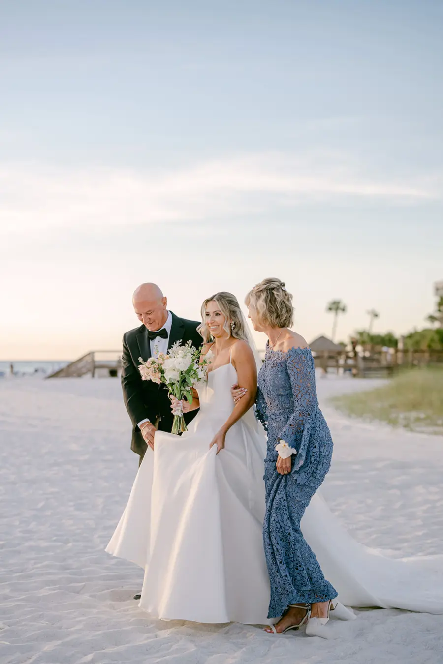 Bride with Mother and Father Walking Down Wedding Aisle | Dusty Blue Mother of the Bride Dress Ideas