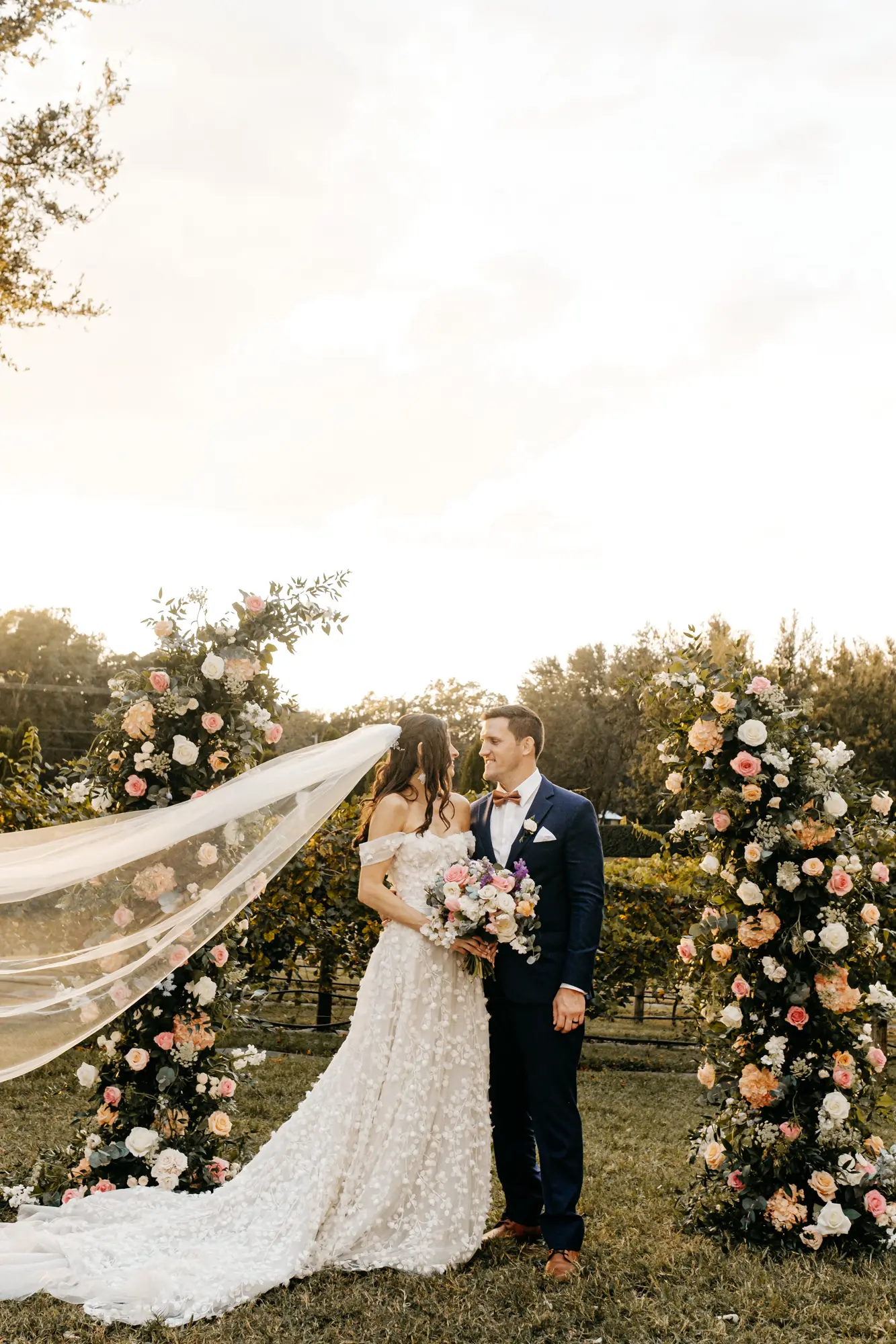 Bride and Groom Just Married Outdoor Vineyard Wedding Ceremony Inspiration | White and Pink Roses, Hydrangeas, and Greenery Decor Ideas | Tampa Bay Event Planner Coastal Coordinating | Florist Monarch Events