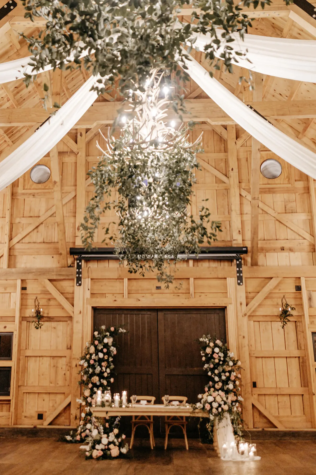 Elegant Garden Inspired White and Pink Rose, and Greenery Barn Wedding Reception Head Table Decor Ideas | Greenery Chandelier Inspiration | Tampa Bay Florist Monarch Events | Venue Mision Lago Estate | Planner Coastal Coordinating