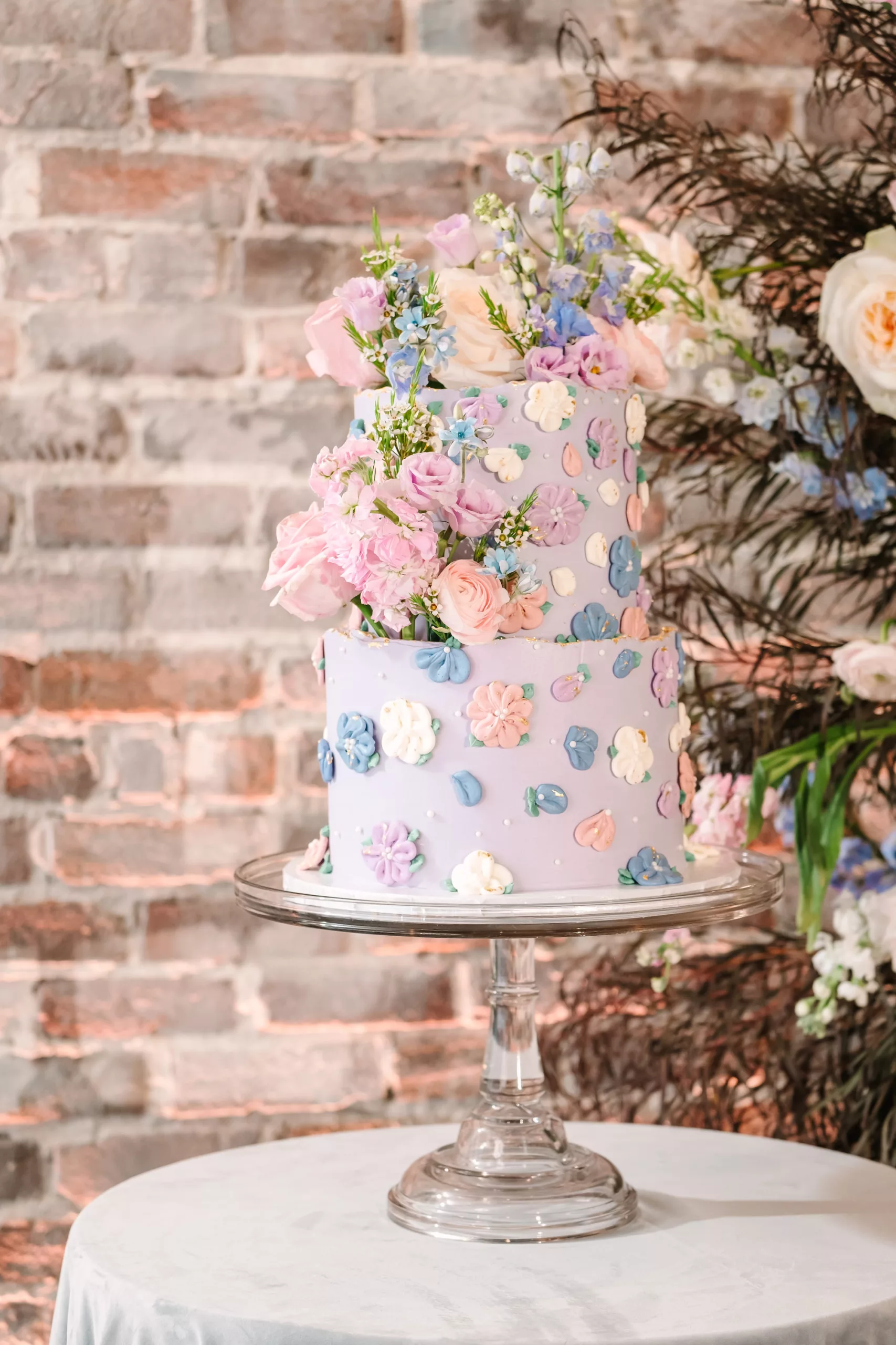 Whimsical Lavender Purple Wedding Cake with Pink, Purple, and Blue Frosting Fowers