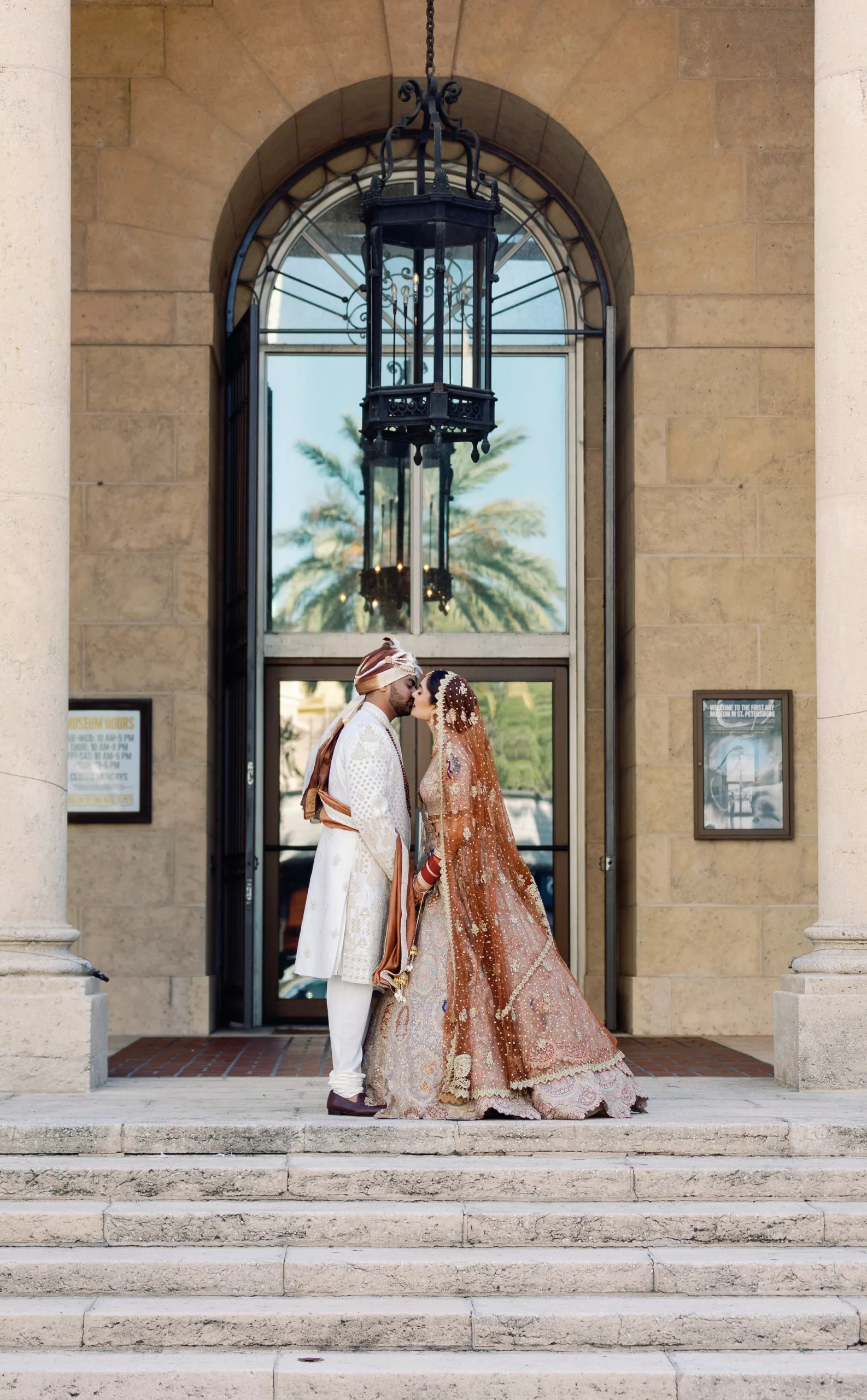 Bride and Groom First Look Wedding Portrait | Neutral Burnt Orange and Cream Beaded Rimple and Harpreet Lehenga Indian Wedding Dress Inspiration | White and Brown Groom's Sherwani Wedding Attire Ideas | Tampa Bay Event Venue Museum of Fine Arts