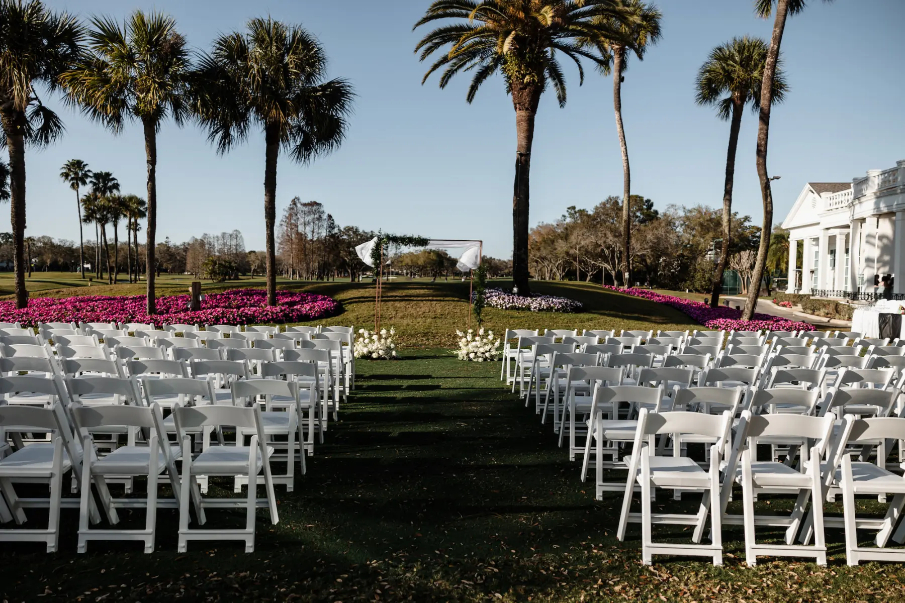Spring Outdoor Golf Course Wedding Ceremony Inspiration | White Folding Garden Chairs | South Tampa Venue Palma Ceia Golf and Country Club