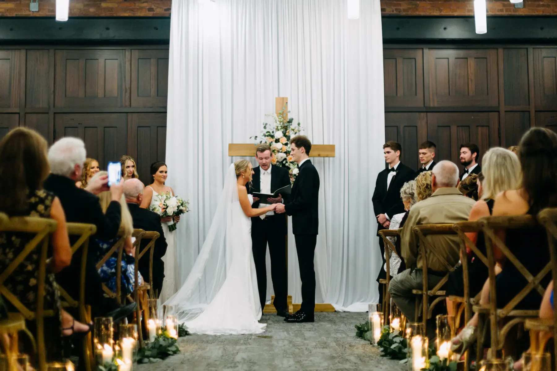 Classic White and Greenery Wedding Ceremony Floral Inspiration with Cross at Altar | Tampa Florist Save the Date Florida | Venue Armature Works | Amber McWhorter Photography