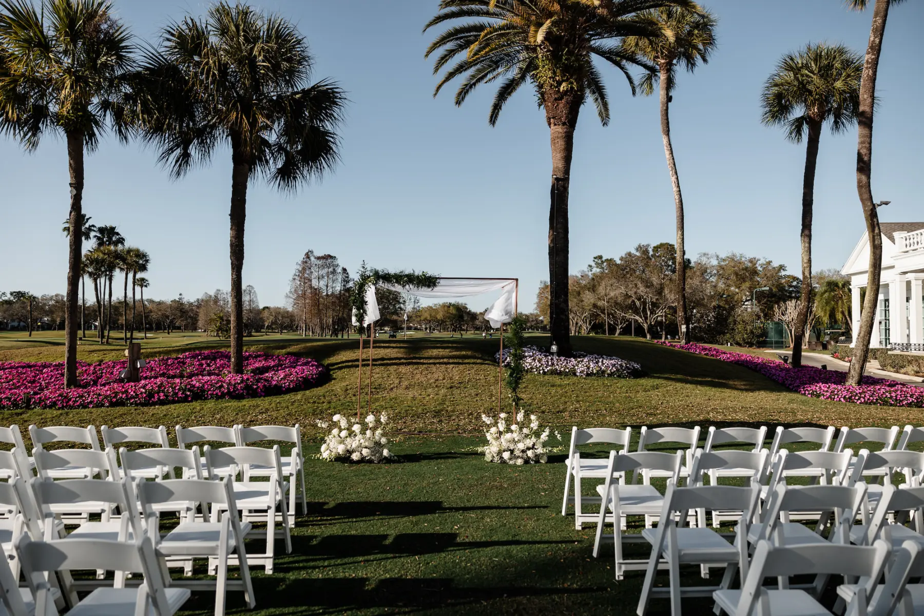 Spring Outdoor Golf Course Wedding Ceremony Inspiration | White Folding Garden Chairs | South Tampa Venue Palma Ceia Golf and Country Club