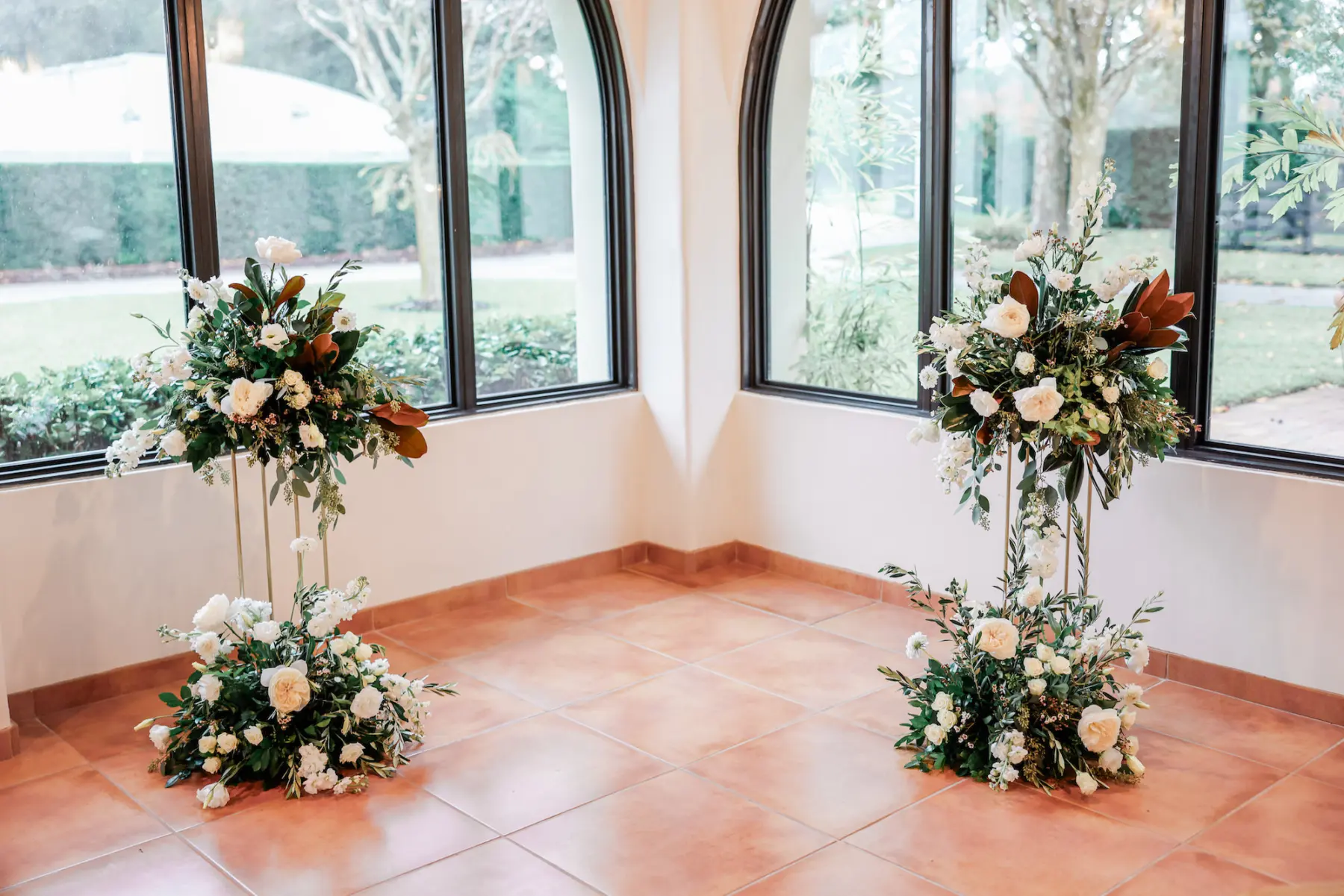 Classic Wedding Ceremony Flower Stand Decor with White Roses, Brown Leaves, and Greenery Floral Arrangement Inspiration | Tampa Bay Vinyard Event Venue Mision Lago Estate