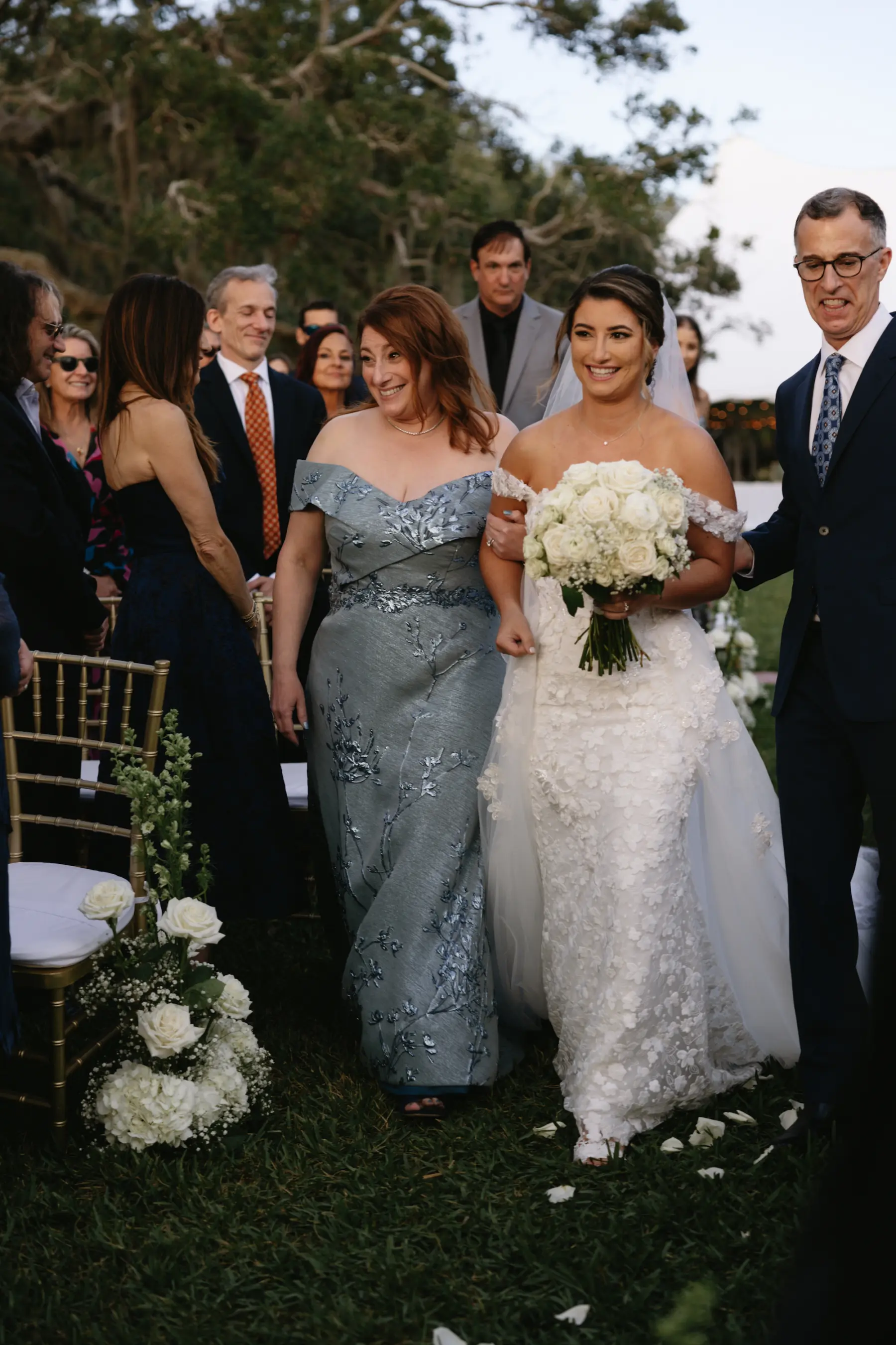 Bride with Mother and Father Walking Down Wedding Aisle