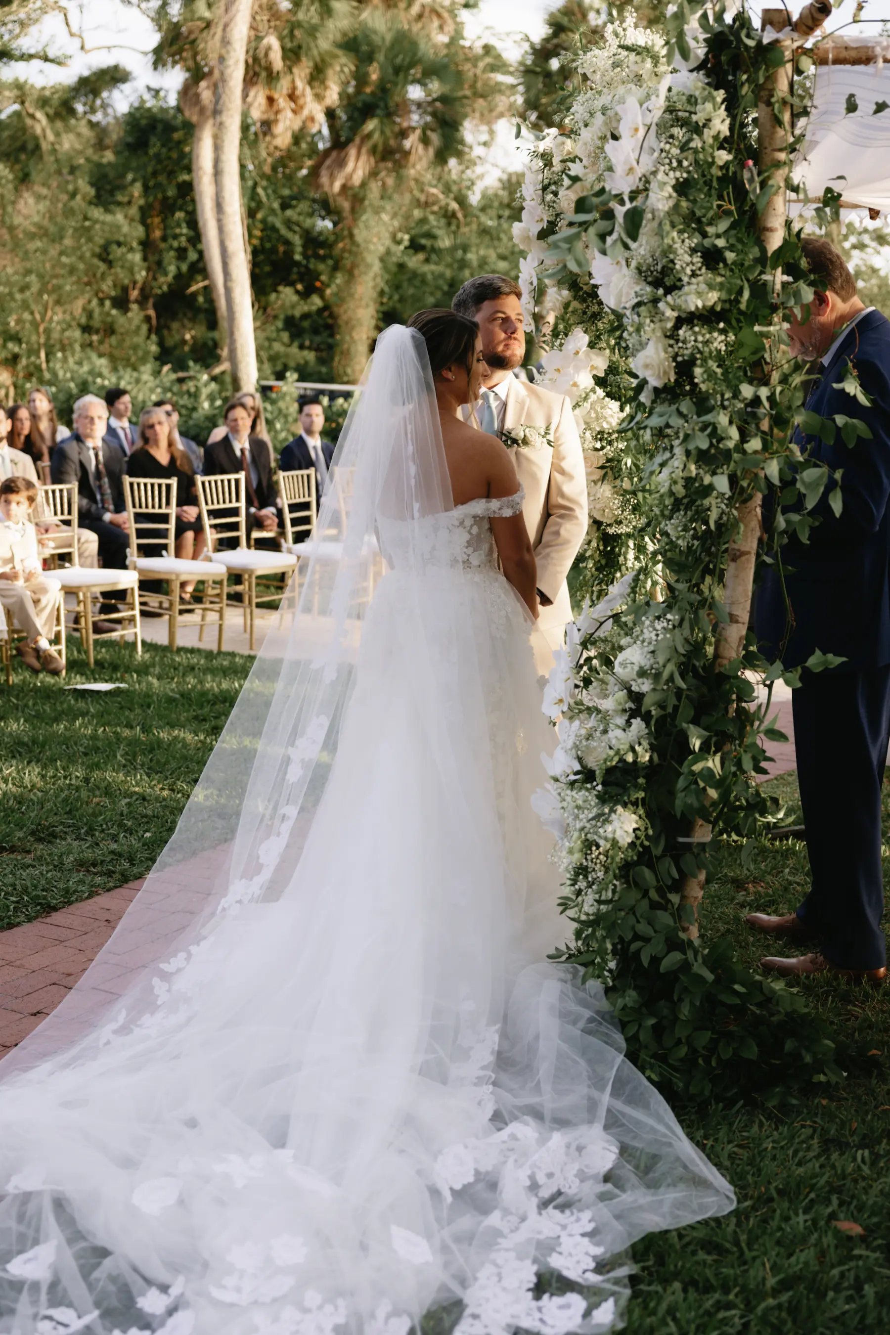 Bride and Groom Outdoor Sunset Wedding Ceremony Ideas | White Off The Shoulder Lace Milla Nova Wedding Dress with Detachable Tulle Train Inspiration