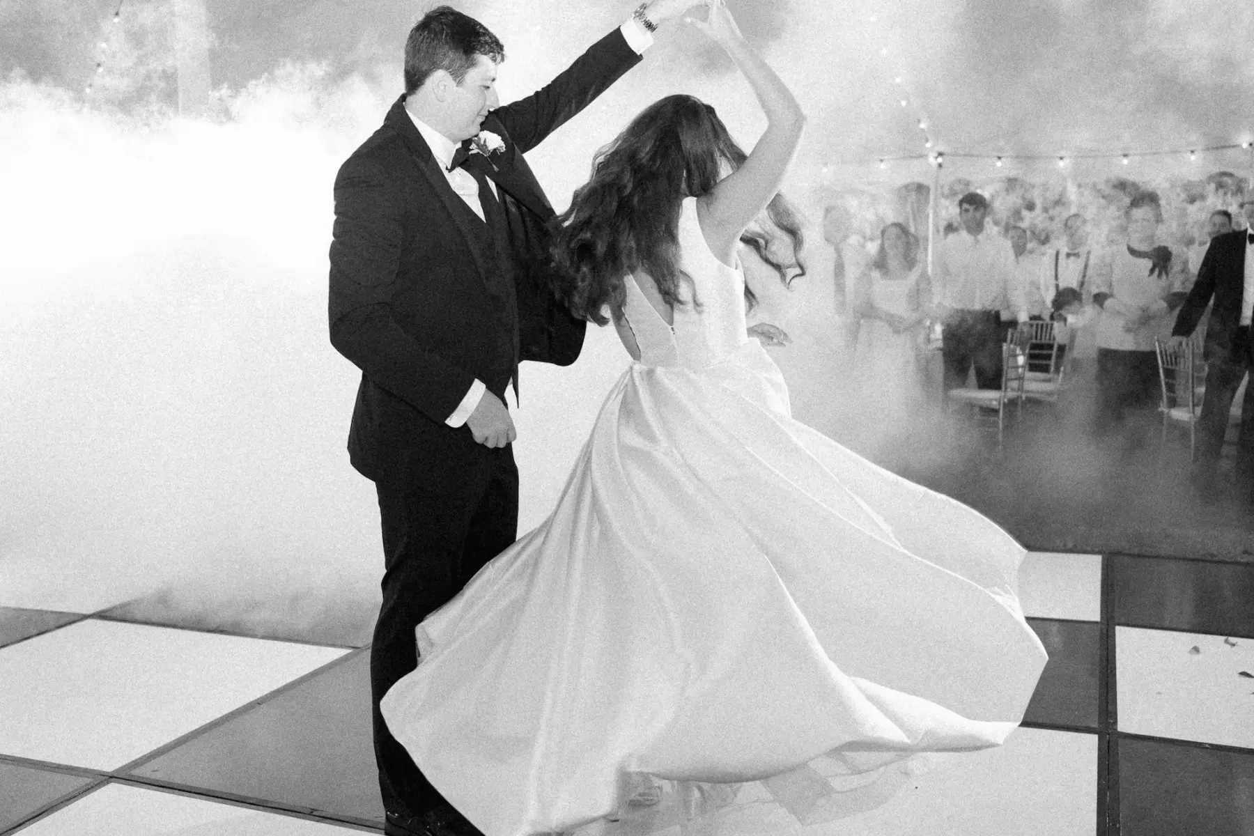 Bride and Groom First Dance With Black and White Checkered Dance Floor and Fog Machine Ideas