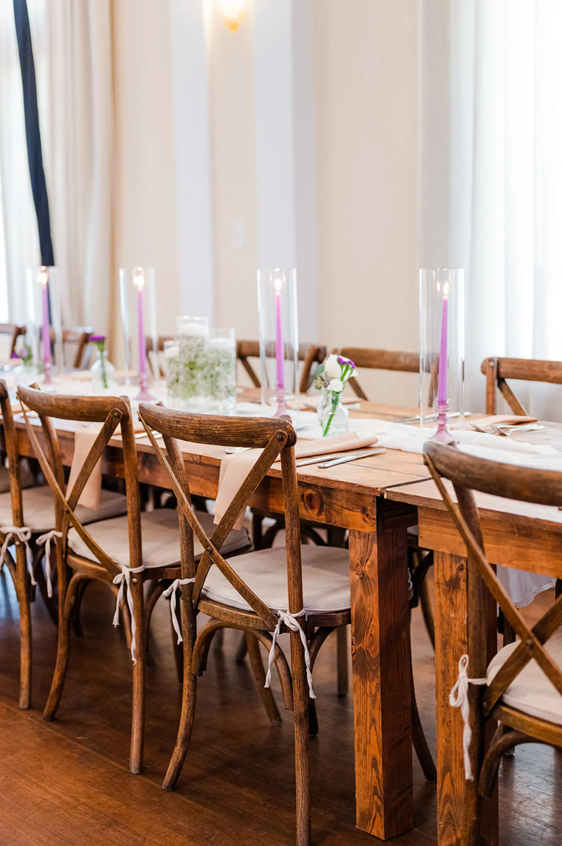 Elegant Spring Wedding Reception Decor Ideas with Wooden Crossback Chairs and Tables and Purple Candle Centerpieces